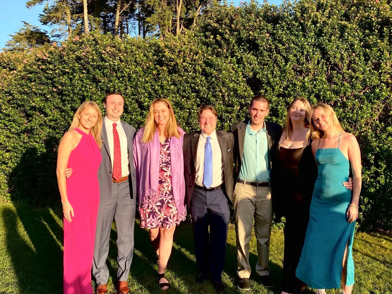 A family photograph captures a happy gathering, with seven loved ones smiling together on a sunny day. Ann had hoped retirement would give her more time to enjoy moments like these with her children and family. | Source: Facebook/@katie.mannix.5