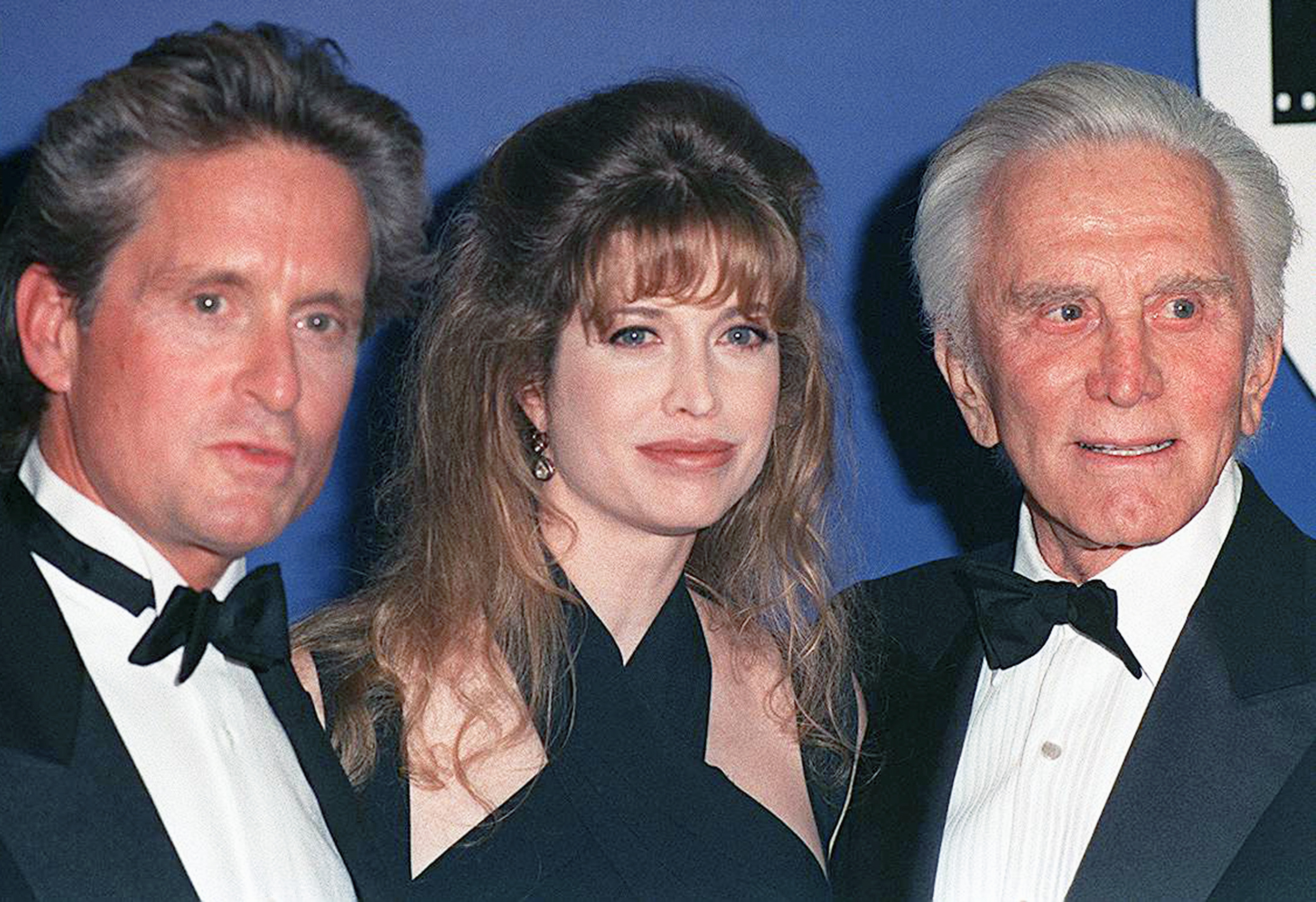 Michael and Kirk Douglas with Diandra Luker Douglas at an event circa 1993. | Source: Getty Images