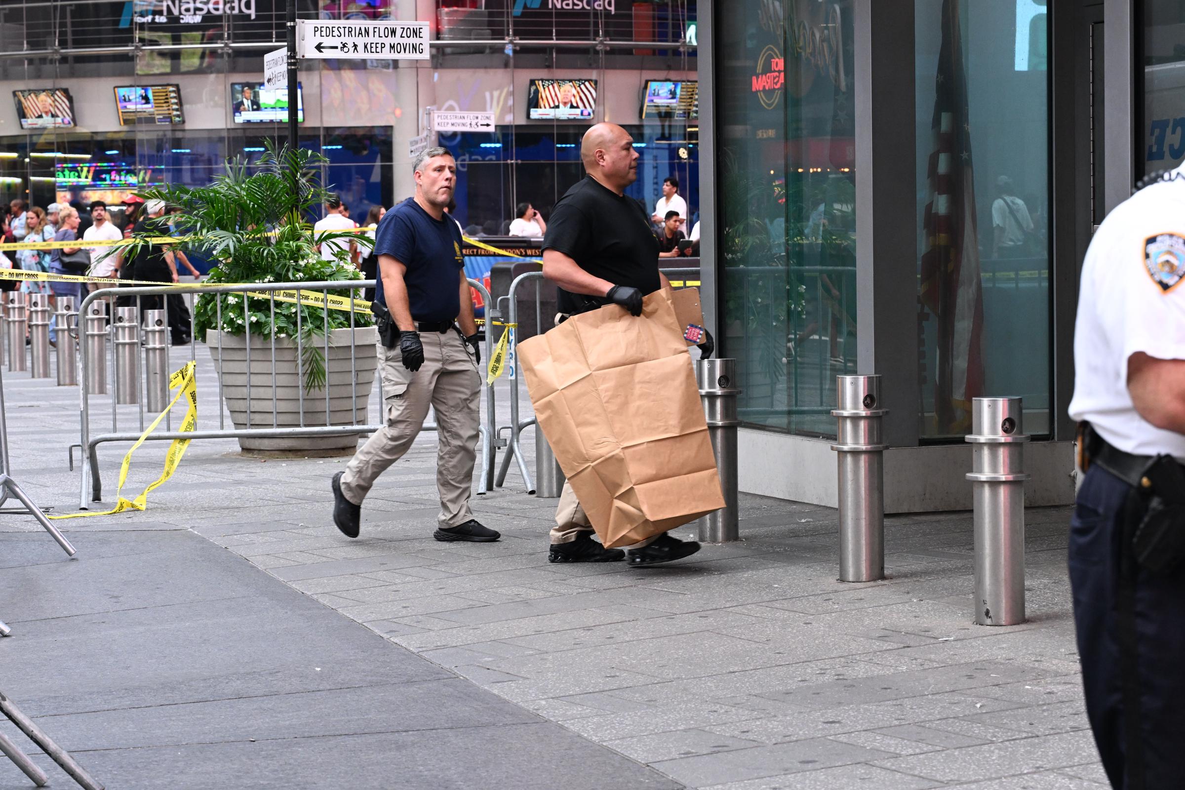 Investigators worked inside the cordoned-off Times Square scene after officers confronted Pamela Cisneros. Police said she was still carrying two knives when they tracked her to an area behind an NYPD substation. | Source: Getty Images