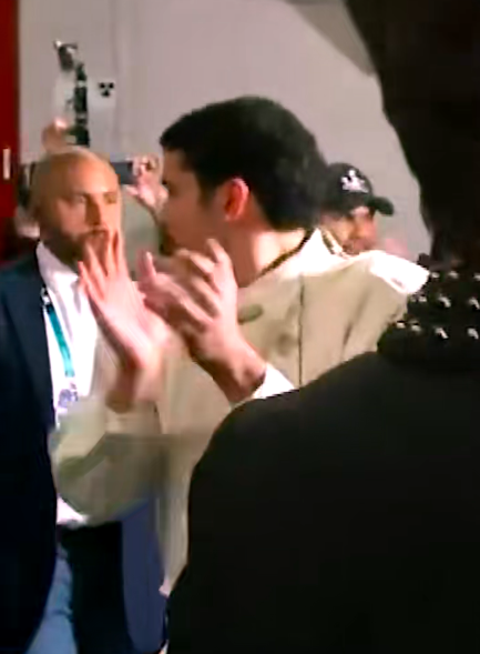 Bad Bunny clapping as he walks briskly among a crowd after his Super Bowl performance, posted on February 8, 2026. | Source: TikTok/@entertainmenttonight