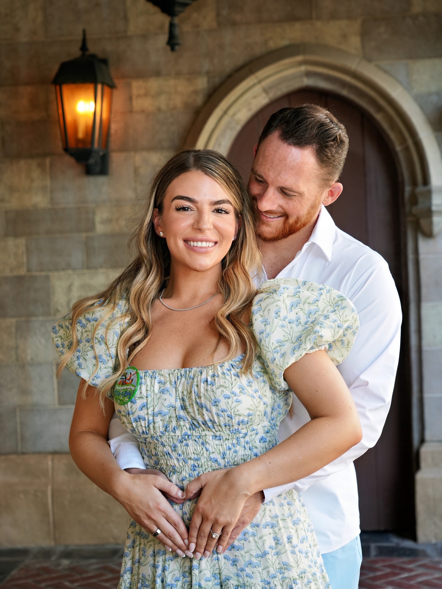 Marissa and Shelby Blackstock pose together during their Disney pregnancy celebration, with the mom-to-be cradling her baby bump. | Source: Instagram/rissablackstock