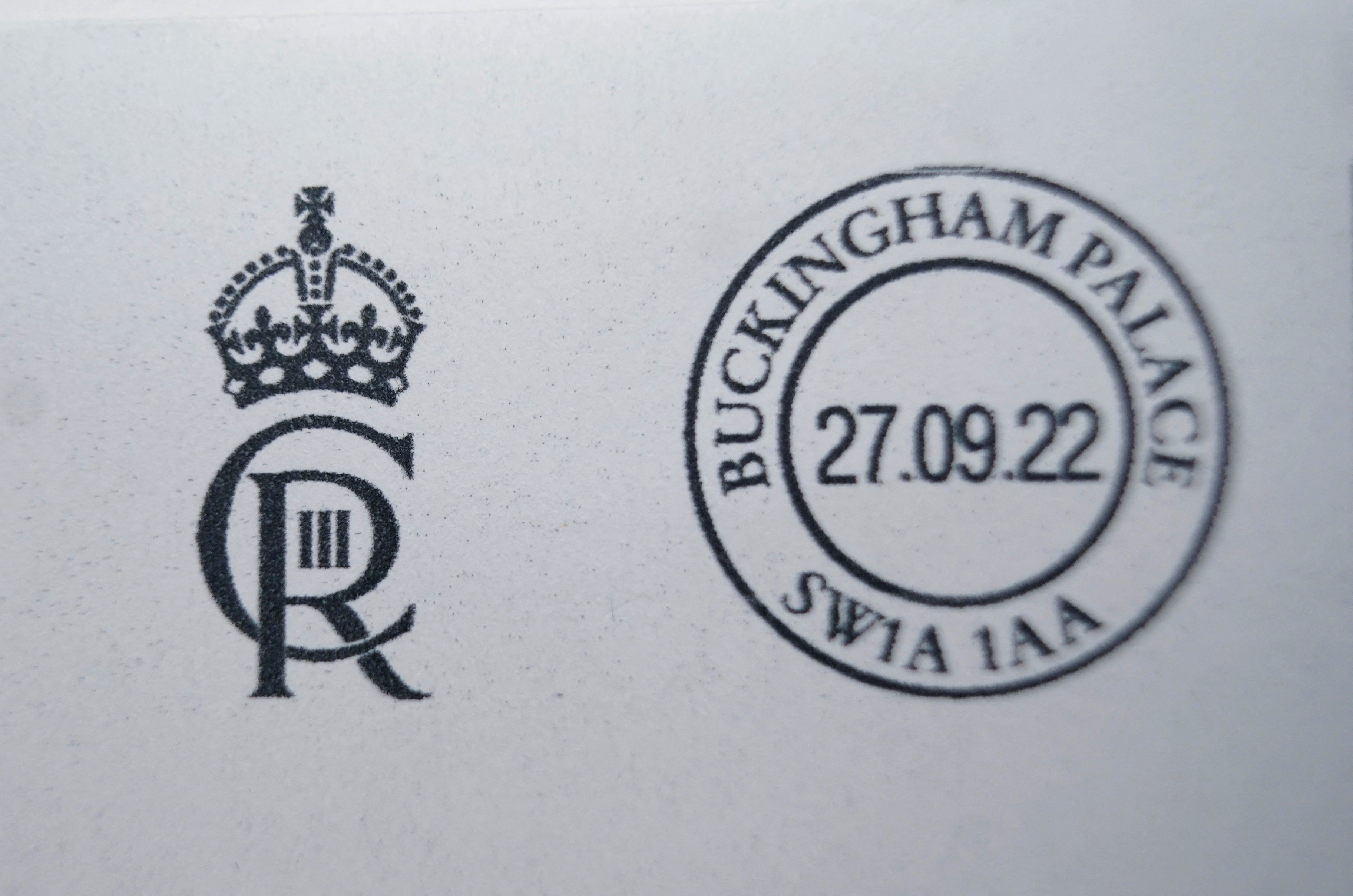 King Charles III's royal cypher combines an interlocking "C" and "R," with "III" representing the third monarch named Charles and a crown above the design. The personal emblem is used on official documents, buildings and other objects associated with the monarch. | Source: Getty Images