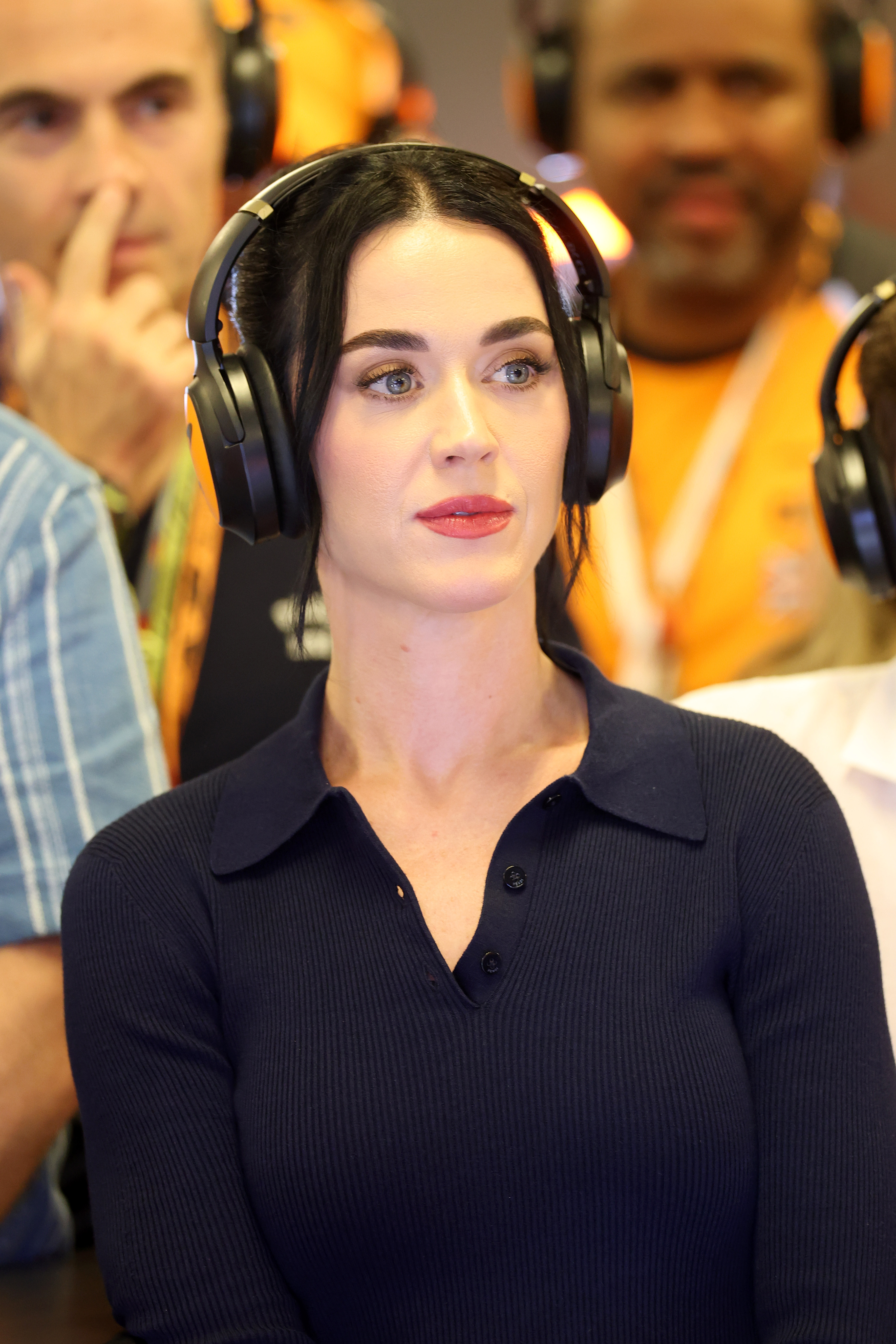 Perry continued making public appearances as questions surrounding her Montecito property connections remained unresolved. She was photographed wearing headphones in the McLaren garage during Formula 1 qualifying in Abu Dhabi on December 6, 2025. | Source: Getty Images