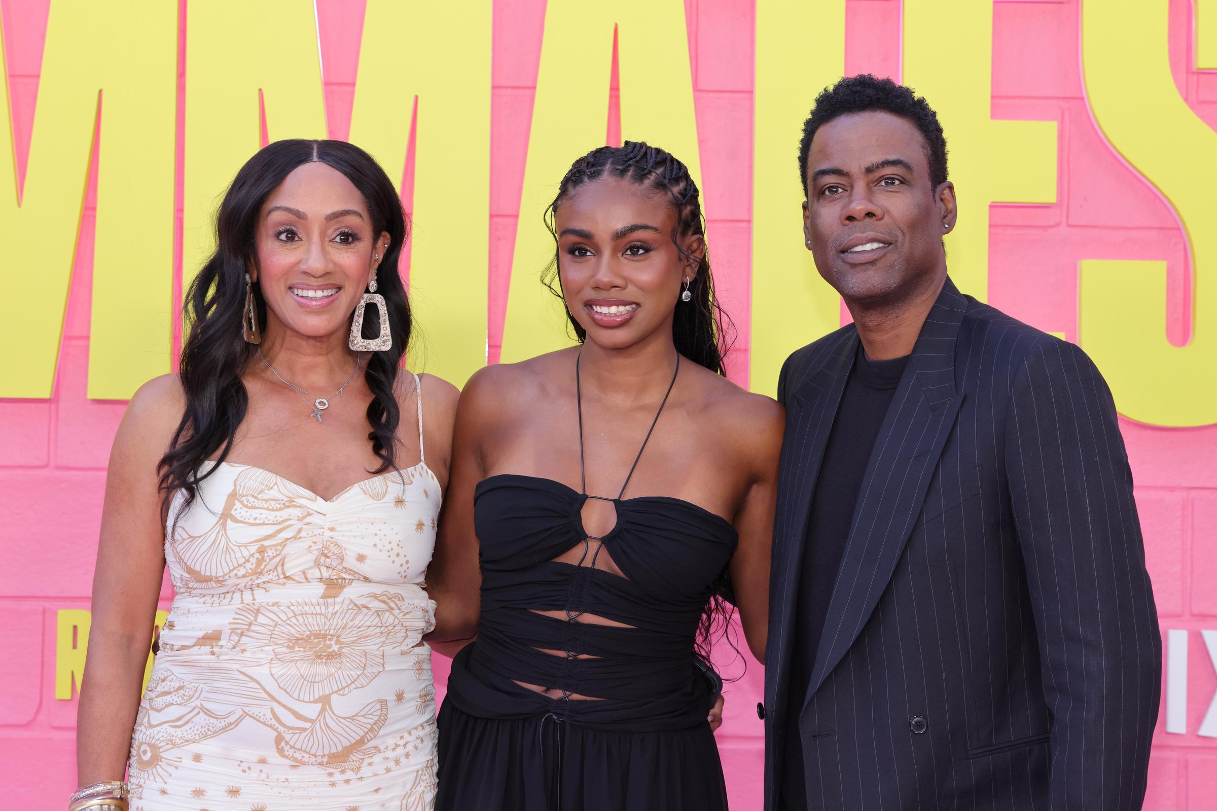 Malaak Compton-Rock, Zahra Rock and Chris Rock attend the premiere of Netflix's "Roommates" at The Egyptian Theater Hollywood in Los Angeles, California on April 13, 2026. | Source: Getty Images