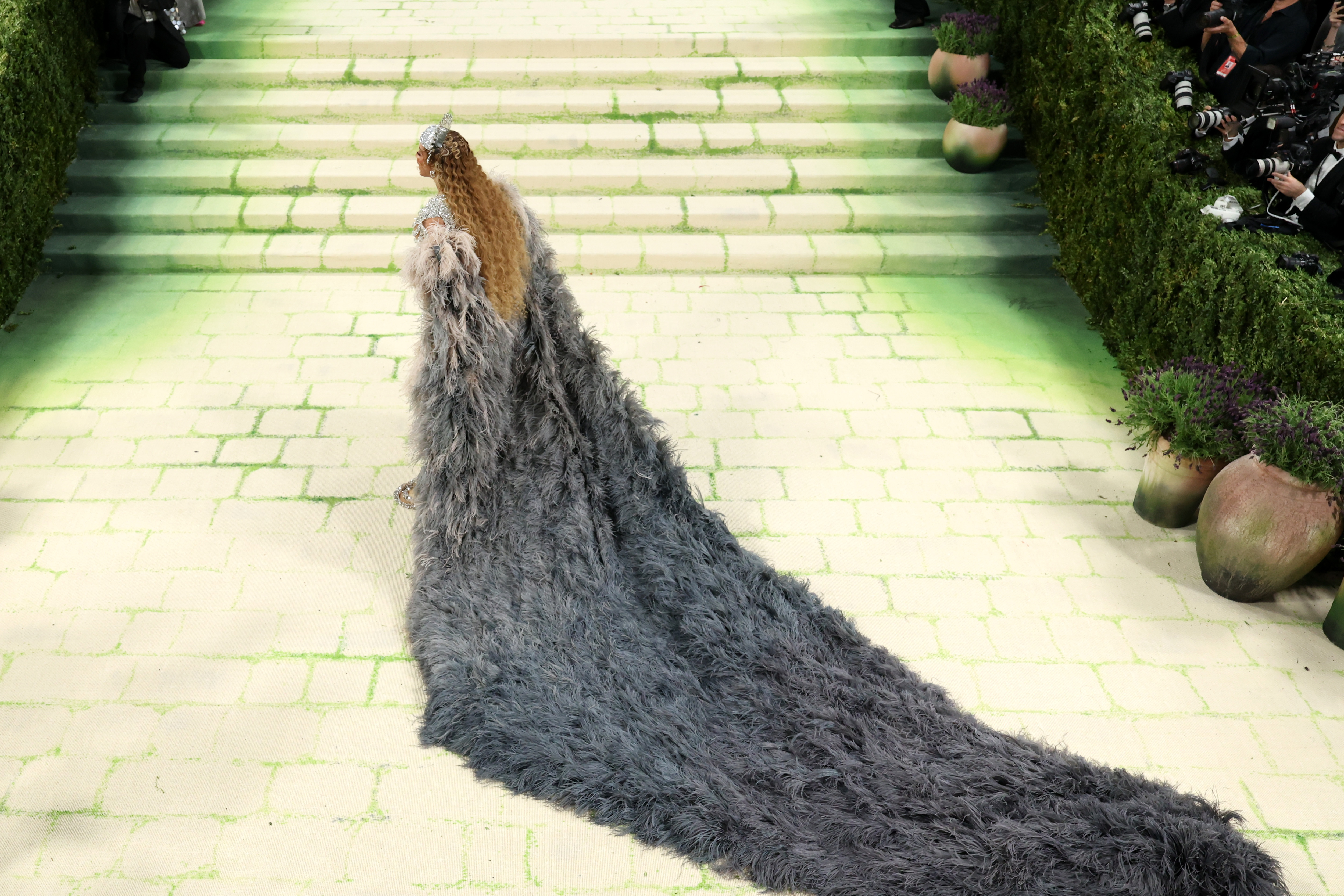 Beyoncé's feathered train stretches behind her as she arrives at the 2026 Met Gala in New York City | Source: Getty Images