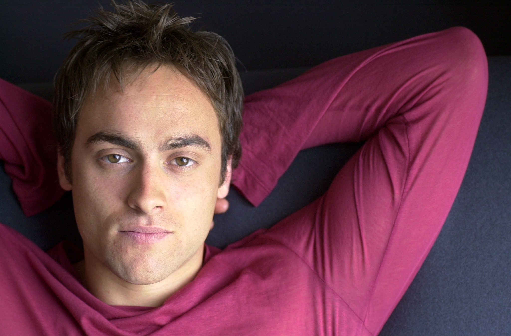 Stuart Townsend relaxed with his arms behind his head at the Bryant Park Hotel on West 40th Street in New York City on March 20, 2001, while promoting his film "About Adam." Dressed in a deep red long-sleeved shirt for the casual portrait, Townsend was appearing as the movie's title character after the earlier casting change on "The Lord of the Rings" redirected Aragorn to Viggo Mortensen.