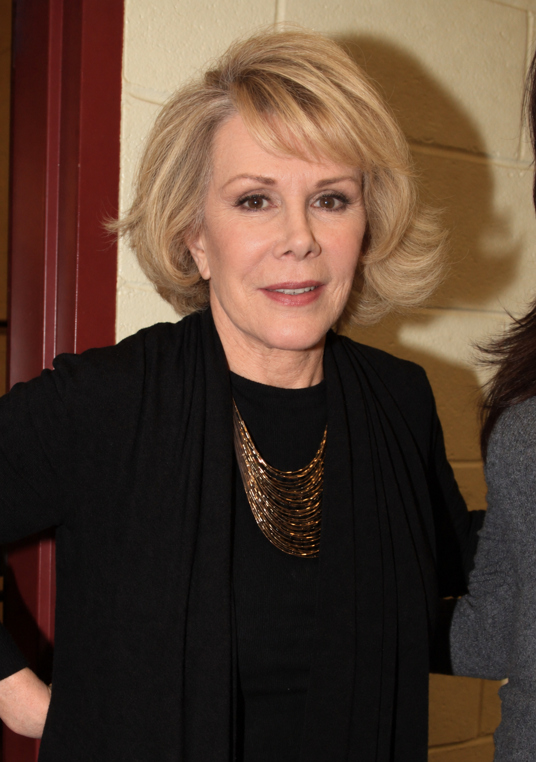 AI gives Joan more pronounced lines around her eyes, cheeks, forehead, and mouth while preserving the recognizable shape and volume of her hairstyle. | Source: ChatGPT