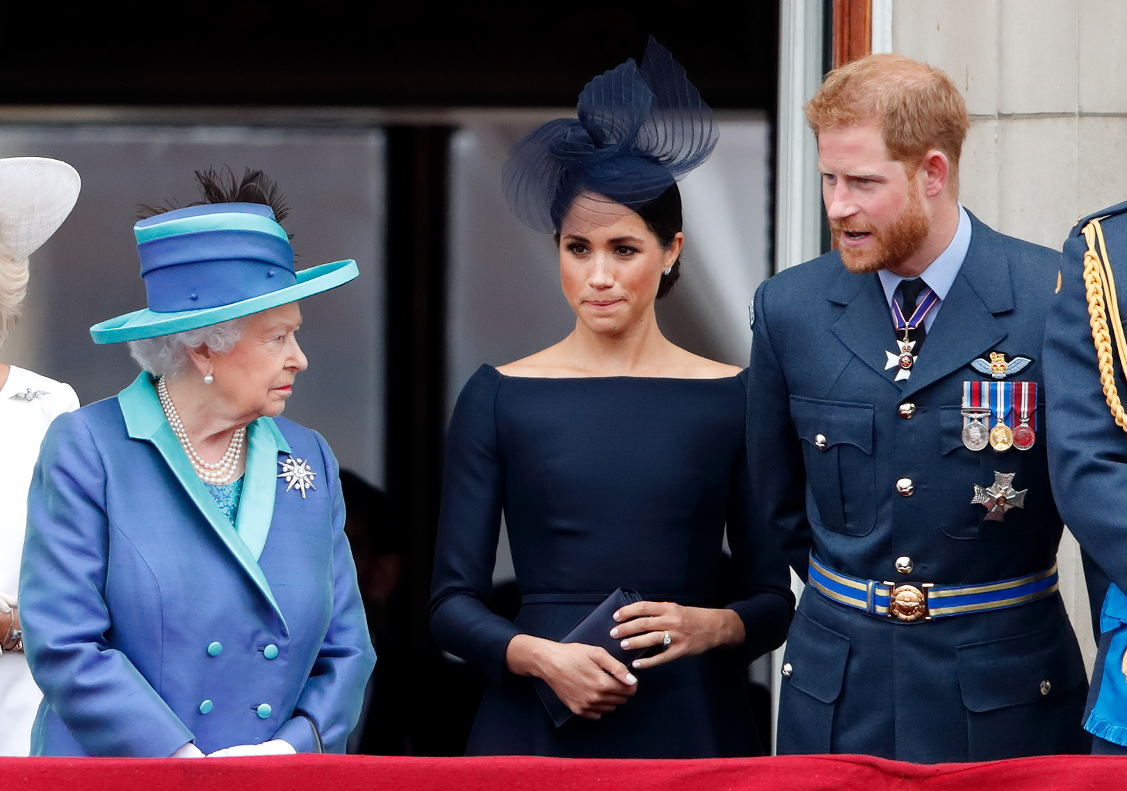 Queen Elizabeth II, Meghan Markle, and Prince Harry, watch a Royal Air Force flypast from the balcony of Buckingham Palace to mark the RAF’s centenary, July 10, 2018 | Source: Getty Images