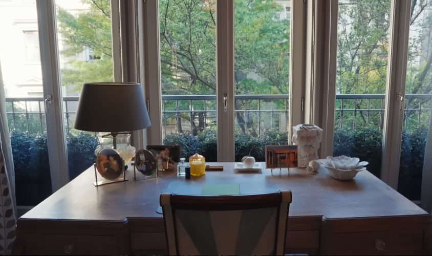 The desk by the windows gives the primary suite a peaceful, almost hotel-like feeling. Its view and personal objects make the room feel elegant without losing warmth. | Source: YouTube/Architectural Digest