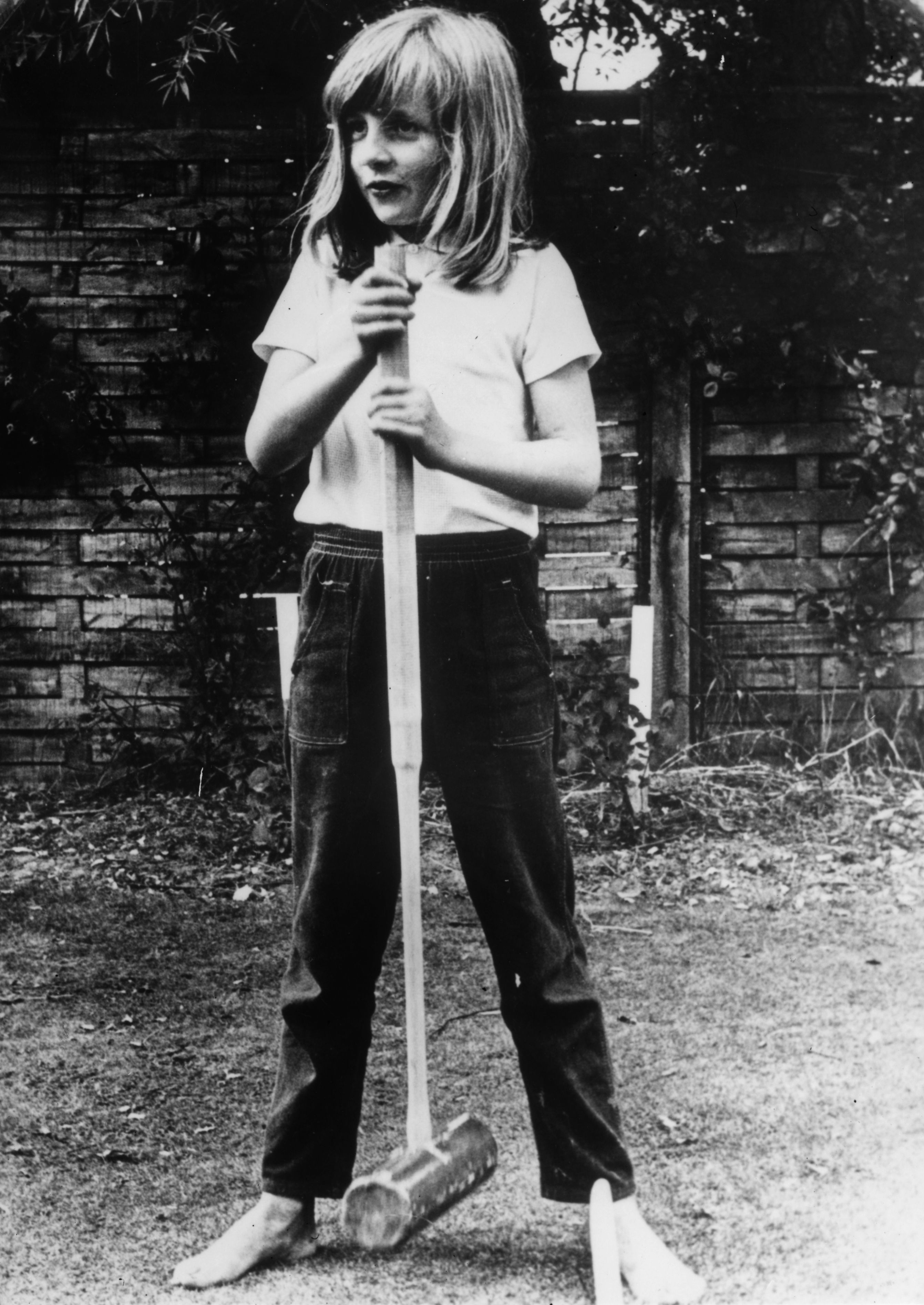 Diana, Princess of Wales, holding a croquet mallet during a game at Itchenor, England, circa 1970. | Source: Getty Images