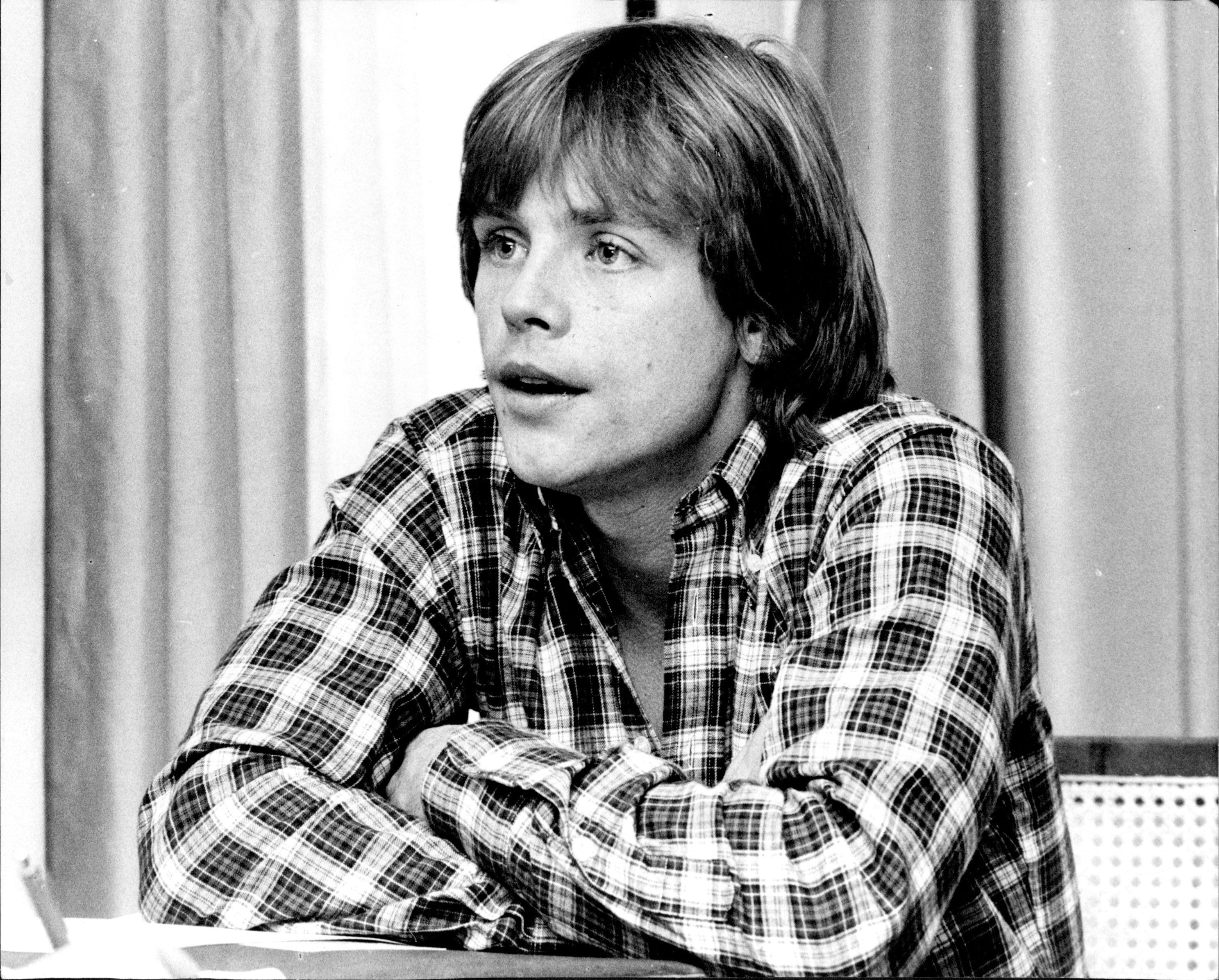 Mark Hamill spoke during an interview at the Sydney Hilton on October 20, 1977, several months after "Star Wars" sent his career in a new direction. Wearing a plaid shirt as he sat with his arms folded, the actor was photographed after his January car crash and subsequent reconstructive treatment. The Sydney appearance showed Hamill amid his sudden rise to stardom as he began navigating opportunities beyond the role of Luke Skywalker.