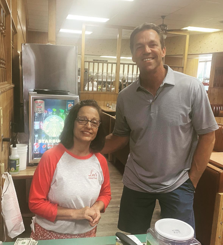 Inside a cozy café, Bryon stands with a staff member — an easy moment that reflects the warmth of Leo’s Good Food. | Source: Instagram/sdbryonnoem