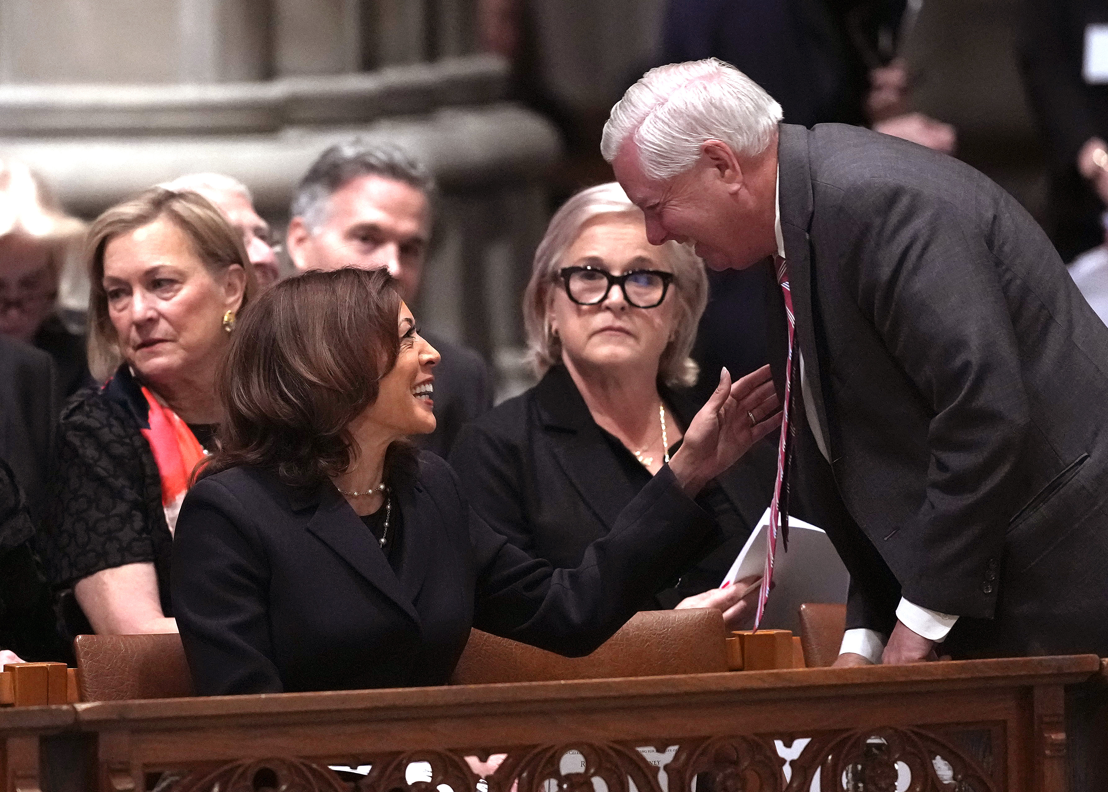 Lindsey Graham shares a warm conversation with former Vice President Kamala Harris during a memorial service, reflecting a rare moment of bipartisan civility at a solemn national gathering. | Source: Getty Images