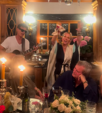 Patrick Muldoon and Shana Muldoon Zappa singing among loved ones gathered around a table, posted on April 20, 2026. | Source: Instagram/shanazappa