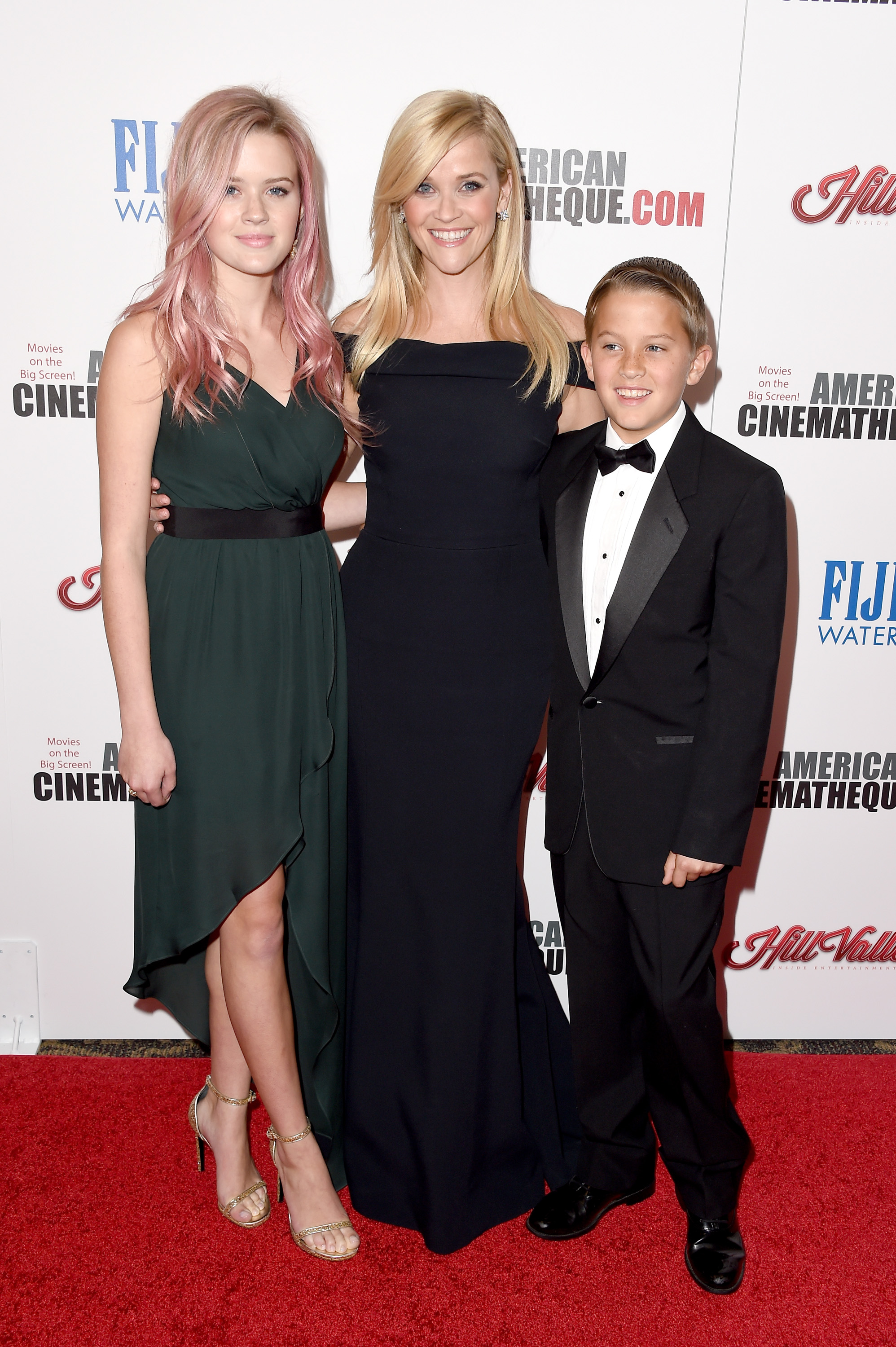 Reese Witherspoon poses with Ava Phillippe and Deacon Phillippe at the American Cinematheque Award ceremony honoring her, standing between her children in a sleek black gown. | Source: Getty Images