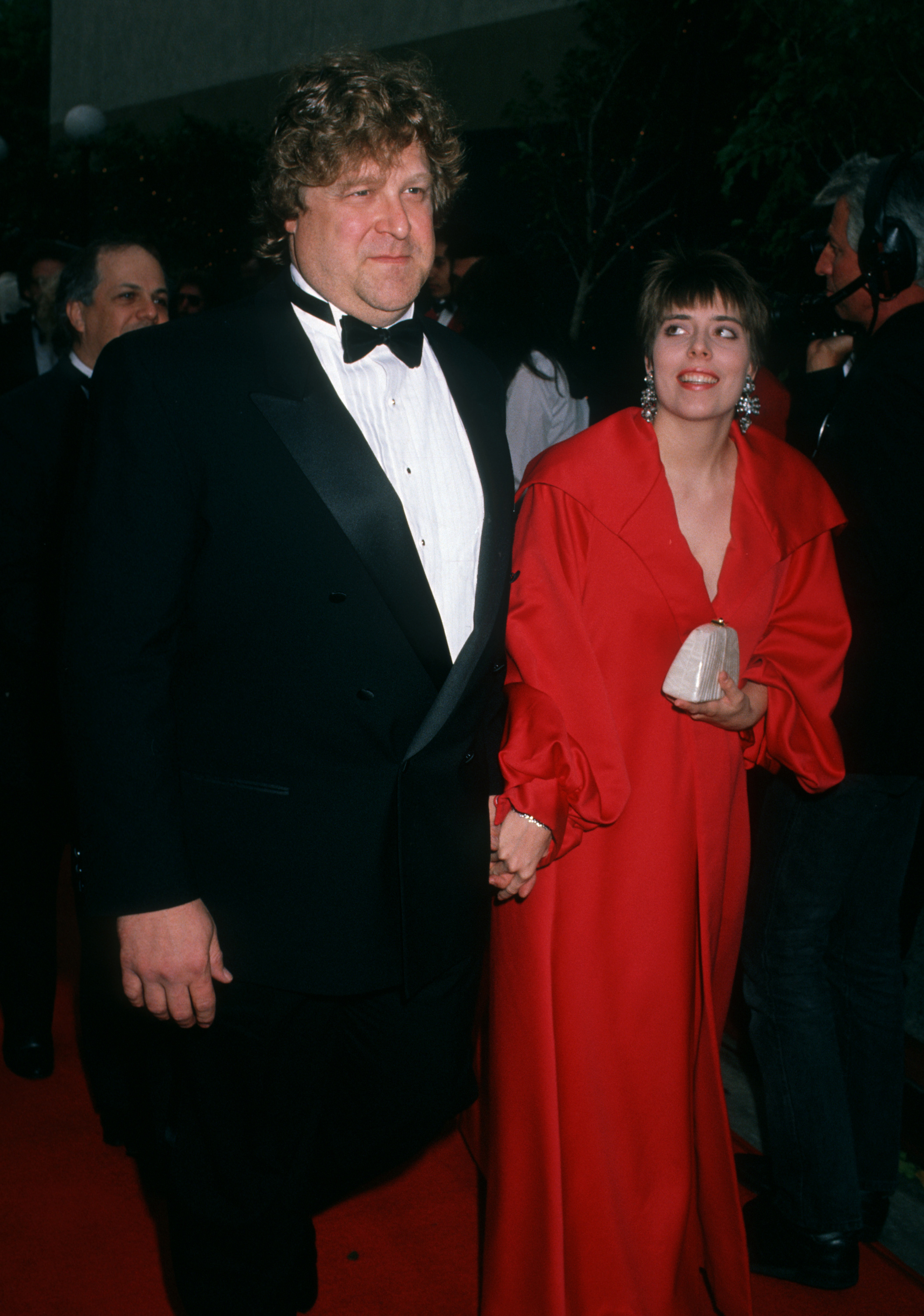 Goodman stepped out with his wife, Anna Beth, for the 16th Annual People's Choice Awards in Universal City, California. He wore a black tuxedo while Anna Beth stood beside him in a bright red dress, documenting the couple together decades before their latest red carpet appearance.