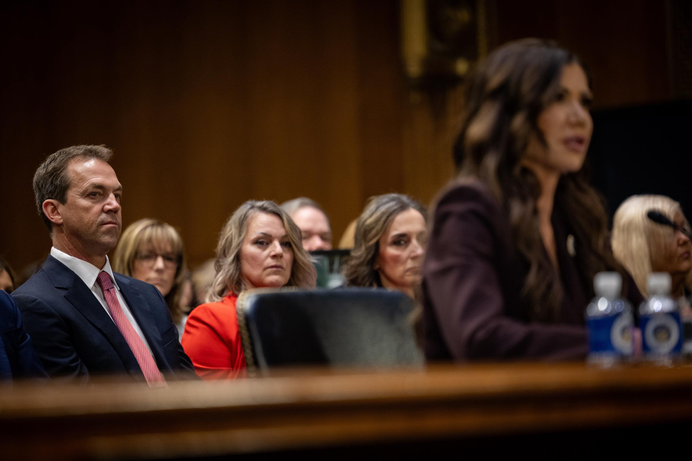 Bryon Noem listens as Secretary of Homeland Security Kristi Noem testifies during a Senate Judiciary Committee oversight hearing for the Department of Homeland Security at the Dirksen Senate Office Building on March 3, 2026, in Washington, D.C. | Source: Getty Images
