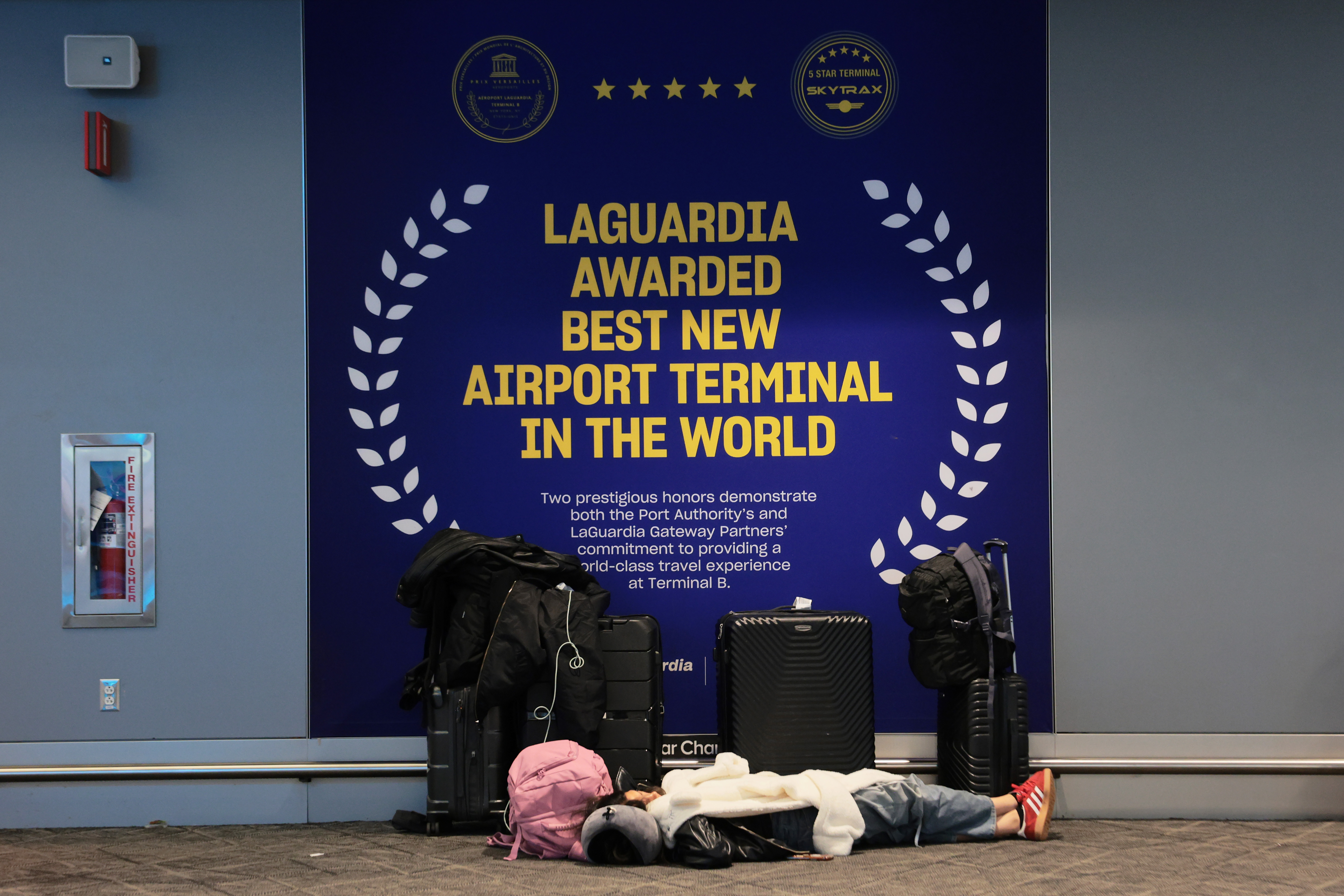 Travelers wait inside Terminal B at LaGuardia Airport during a ground stop following an overnight accident involving an Air Canada Express CRJ-900 collision with a Port Authority fire truck on March 23, 2026, in New York City | Getty Images