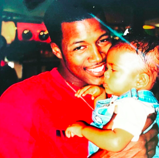 A throwback photo of Flex Alexander holding his daughter when she was a baby, posted on October 24, 2023. | Source: Instagram/flexaforeal