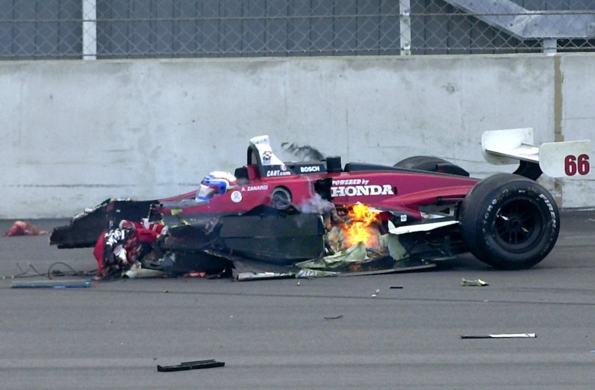 Alex Zanardi's racing car burns following his accident during the CART FedEx Championship Series at the Euro Speedway in Klettwitz, Germany, on September 15, 2001. | Source: Getty Images
