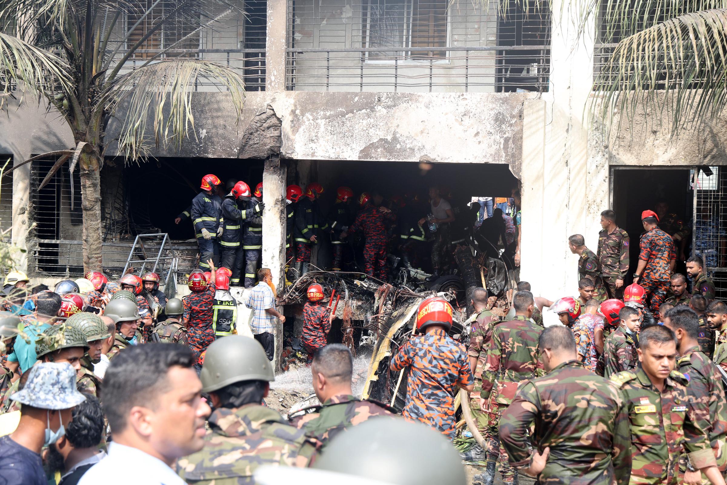 Members of the Bangladesh Army and the fire service start rescue operations after a Bangladesh Air Force F7 aircraft crashed into a building of Milestone College in Dhaka's Uttara in Dhaka, Bangladesh on July 21, 2025 | Source: Getty Images