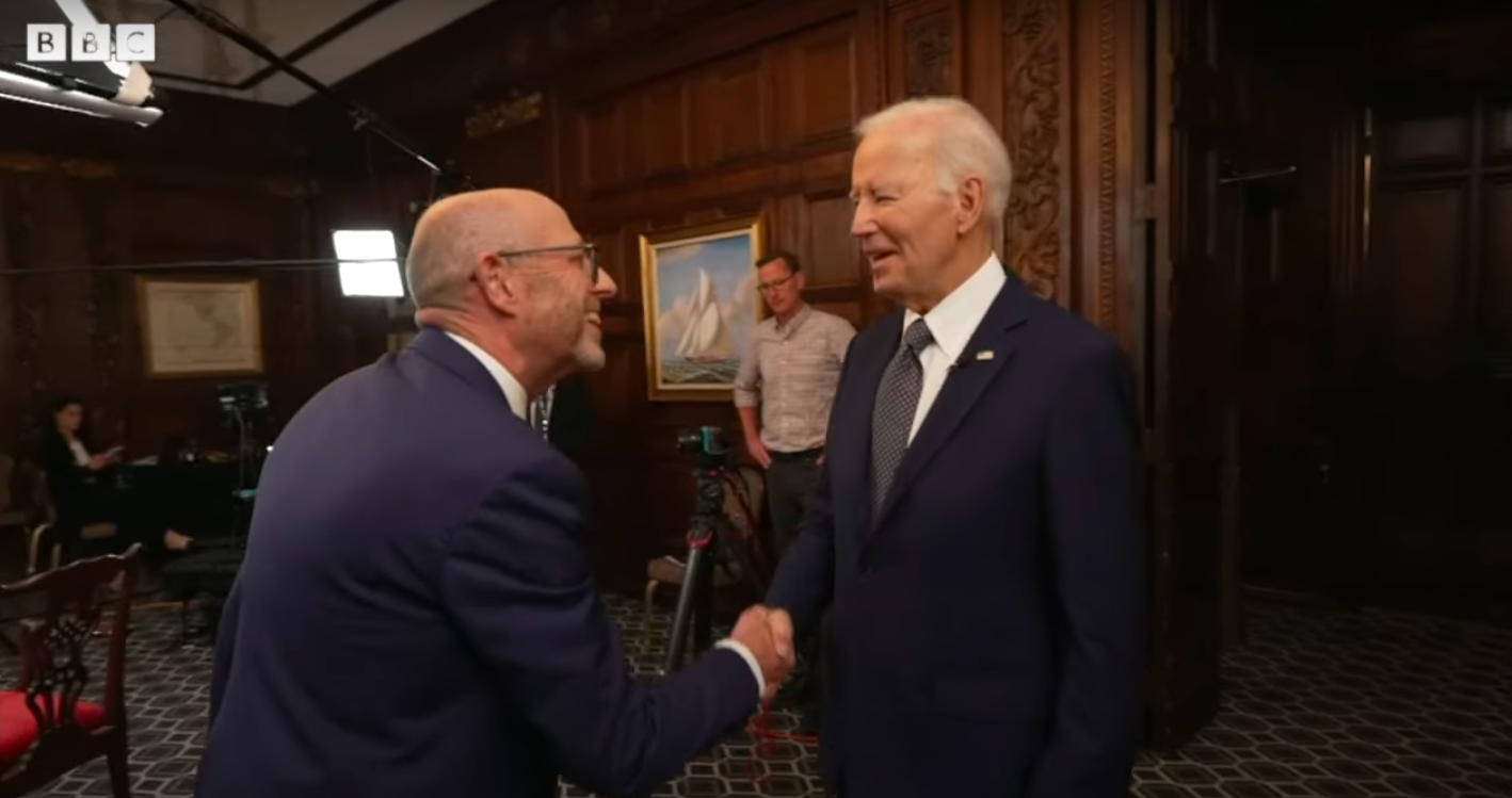 Nick Robinson and Joe Biden shaking hands before the interview began, posted on May 7, 2025. | Source: YouTube/BBC News