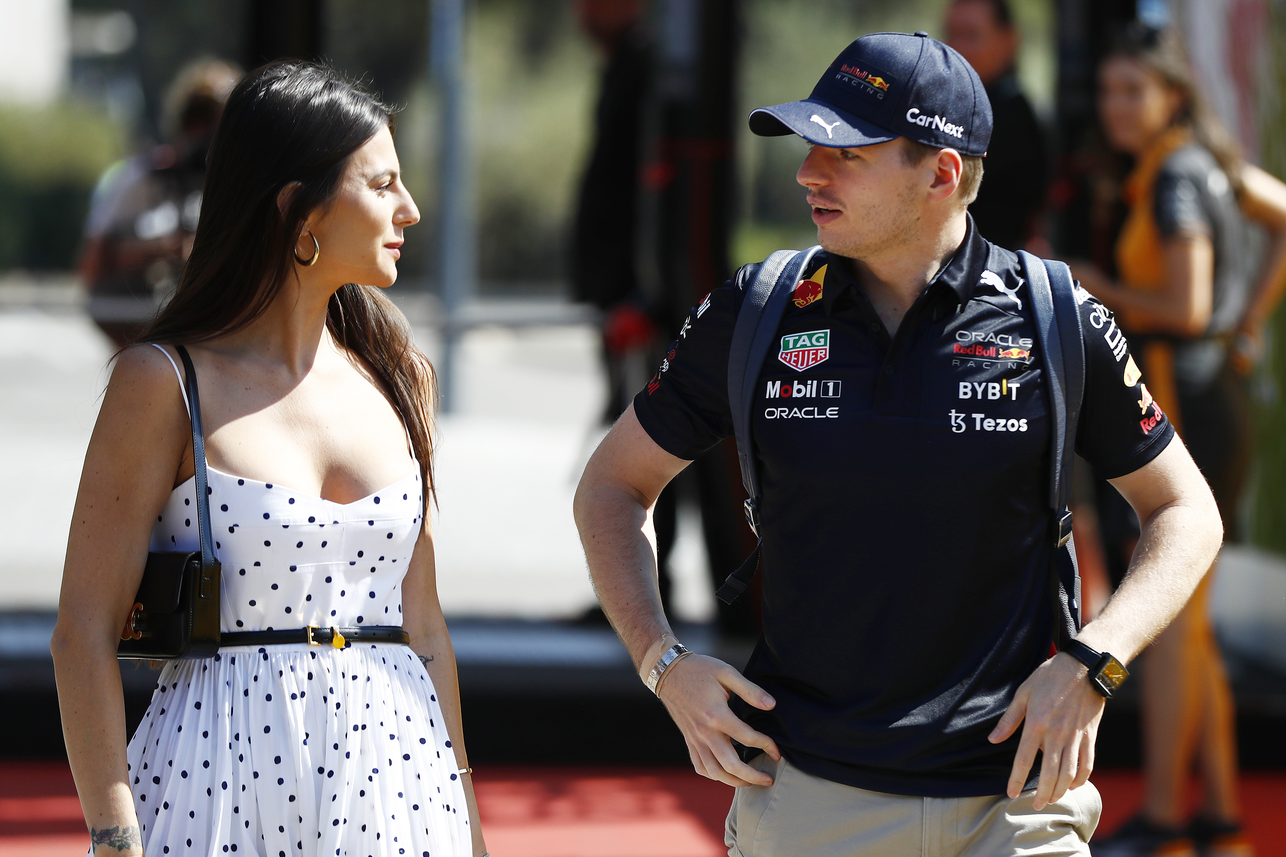 Kelly Piquet and Max Verstappen arrive into the paddock during the French Grand Prix at Circuit Paul Ricard in Le Castellet, France, on July 24, 2022, capturing a stylish moment as the couple entered the track area.