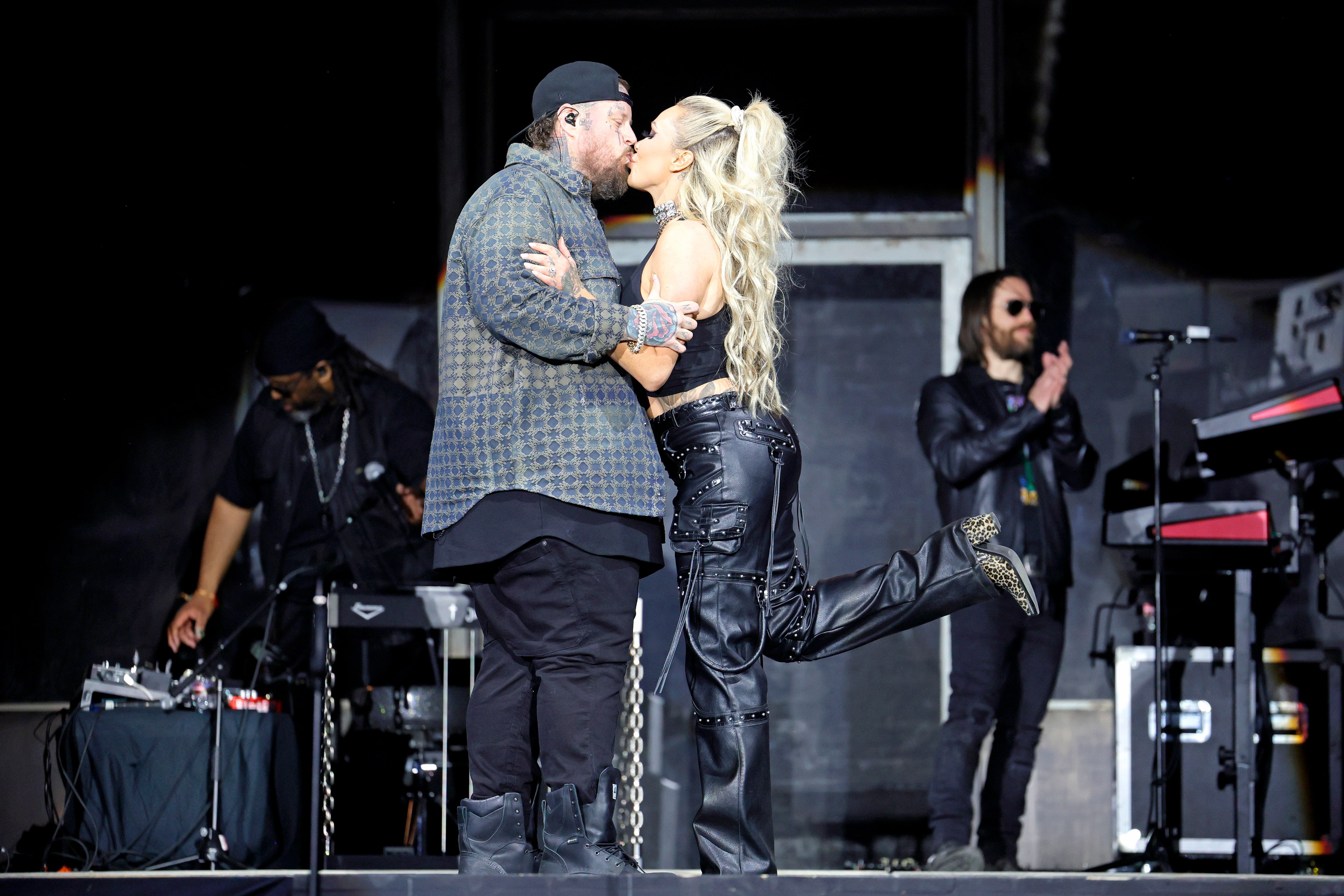 Jelly Roll and Bunnie XO share a kiss onstage during a live appearance. Years before the current divorce headlines, Bunnie spoke candidly about overcoming adversity and believing that "everything's going to work out no matter what" despite the obstacles she faced throughout her life. | Source: Getty Images