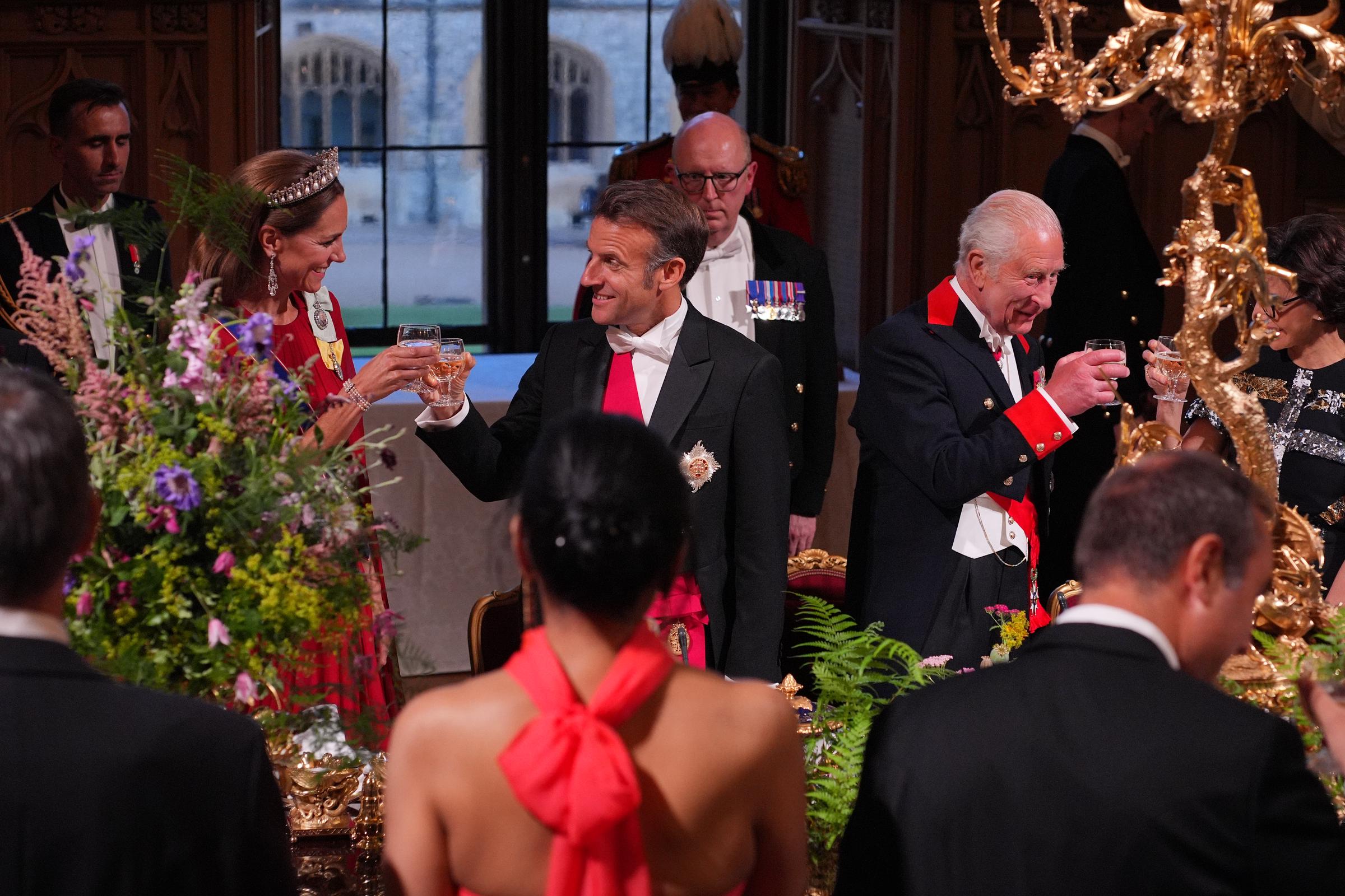French President is photographed clinking his glass with Princess Catherine's during the state banquet held in Windsor Castle, west London. The dinner was attended by several royalties and dignitaries.