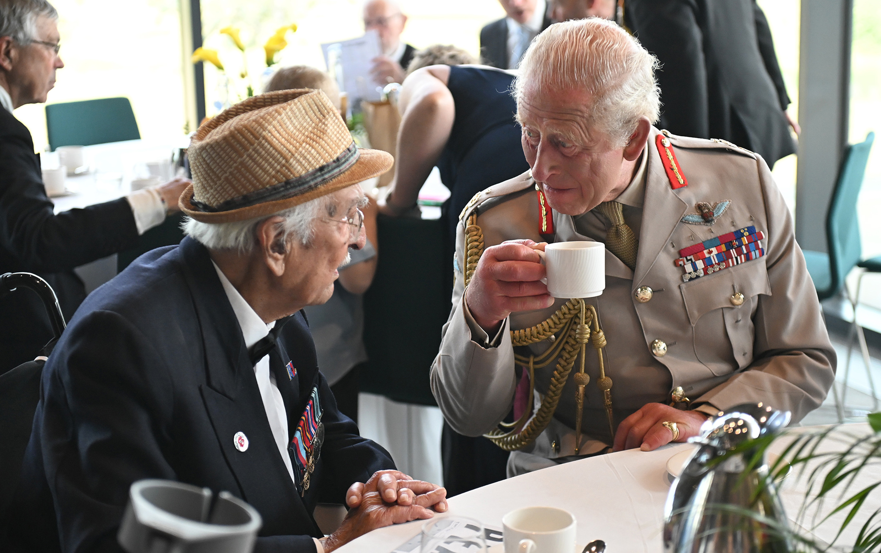 King Charles III talks with Yavar Abbas during a Service of Remembrance to commemorate the 80th Anniversary of VJ Day at The National Memorial Arboretum on August 15, 2025, in Alrewas, Staffordshire | Source: Getty Images