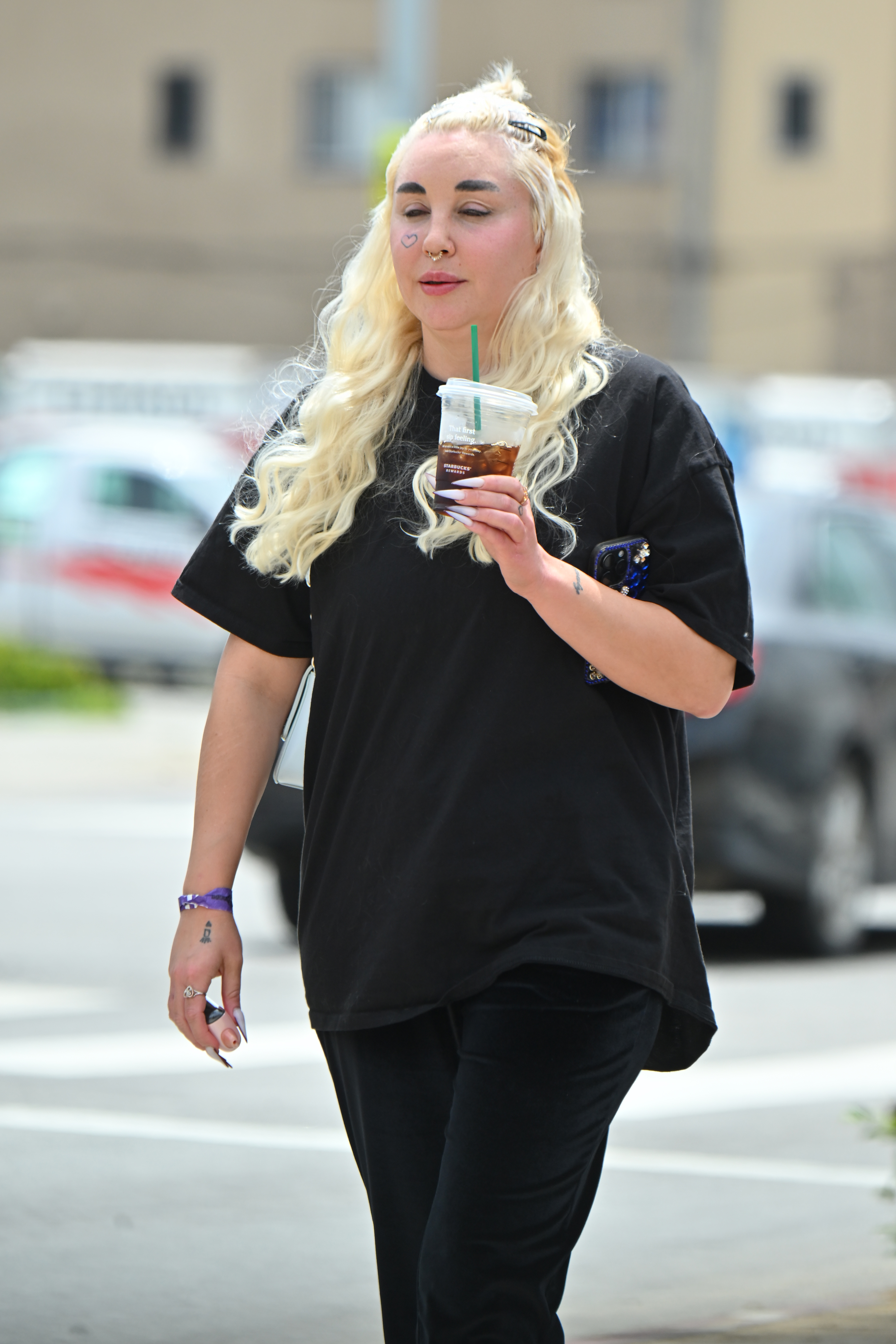 Amanda Bynes holding an iced coffee during a casual outing in Los Angeles on April 25, 2024.
