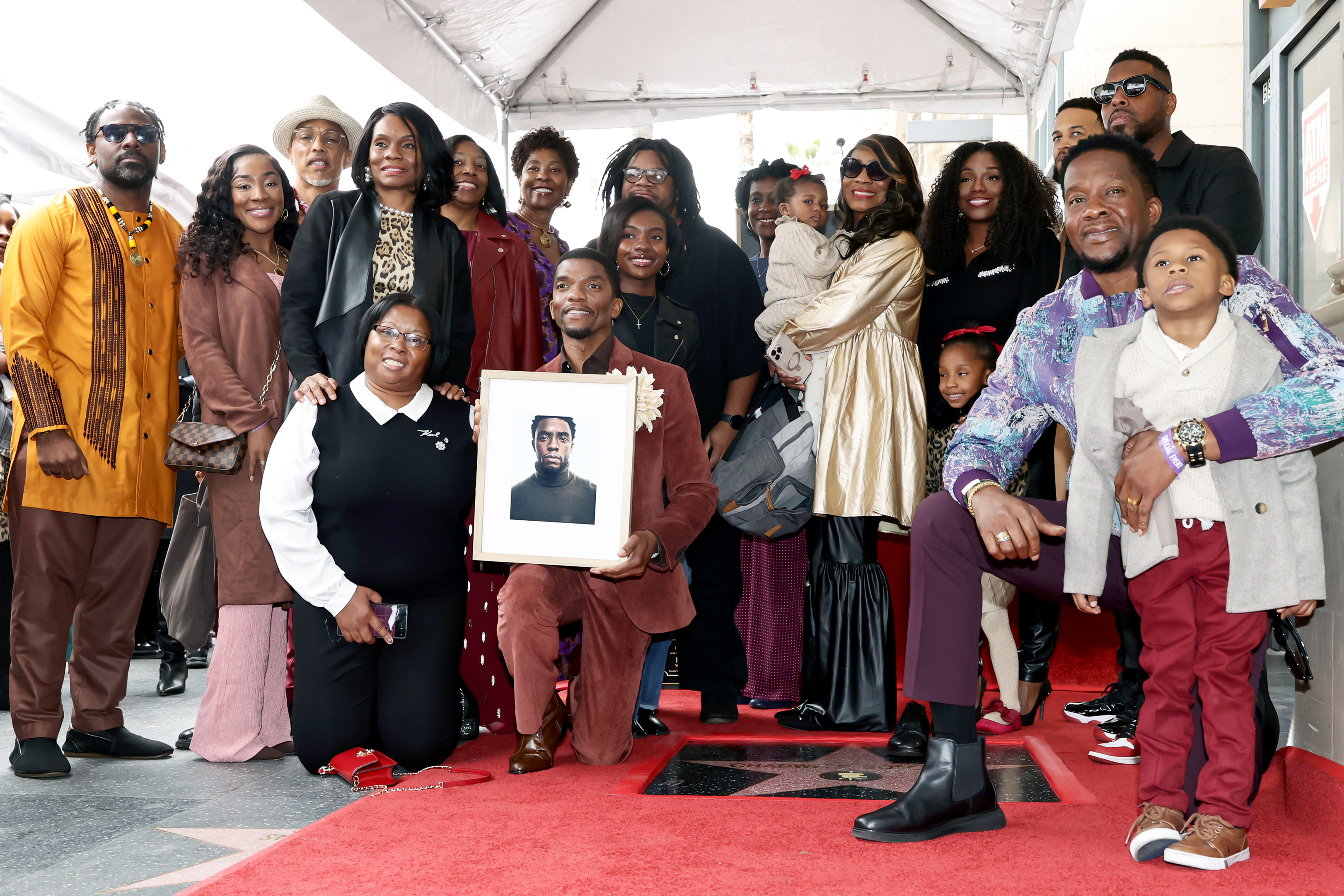 Chadwick Boseman's loved ones pose during the ceremony honoring the actor with a posthumous Star on the Hollywood Walk of Fame in California on November 20, 2025. | Source: Getty Images