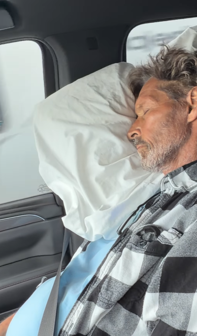 Ron Duguay rests against a pillow in a vehicle, showing a quieter side of his cancer battle. His daughter, Shay Thomas, later explained that he had been feeling extremely weak and uncomfortable during treatment. | Source: Instagram/mrs__shay
