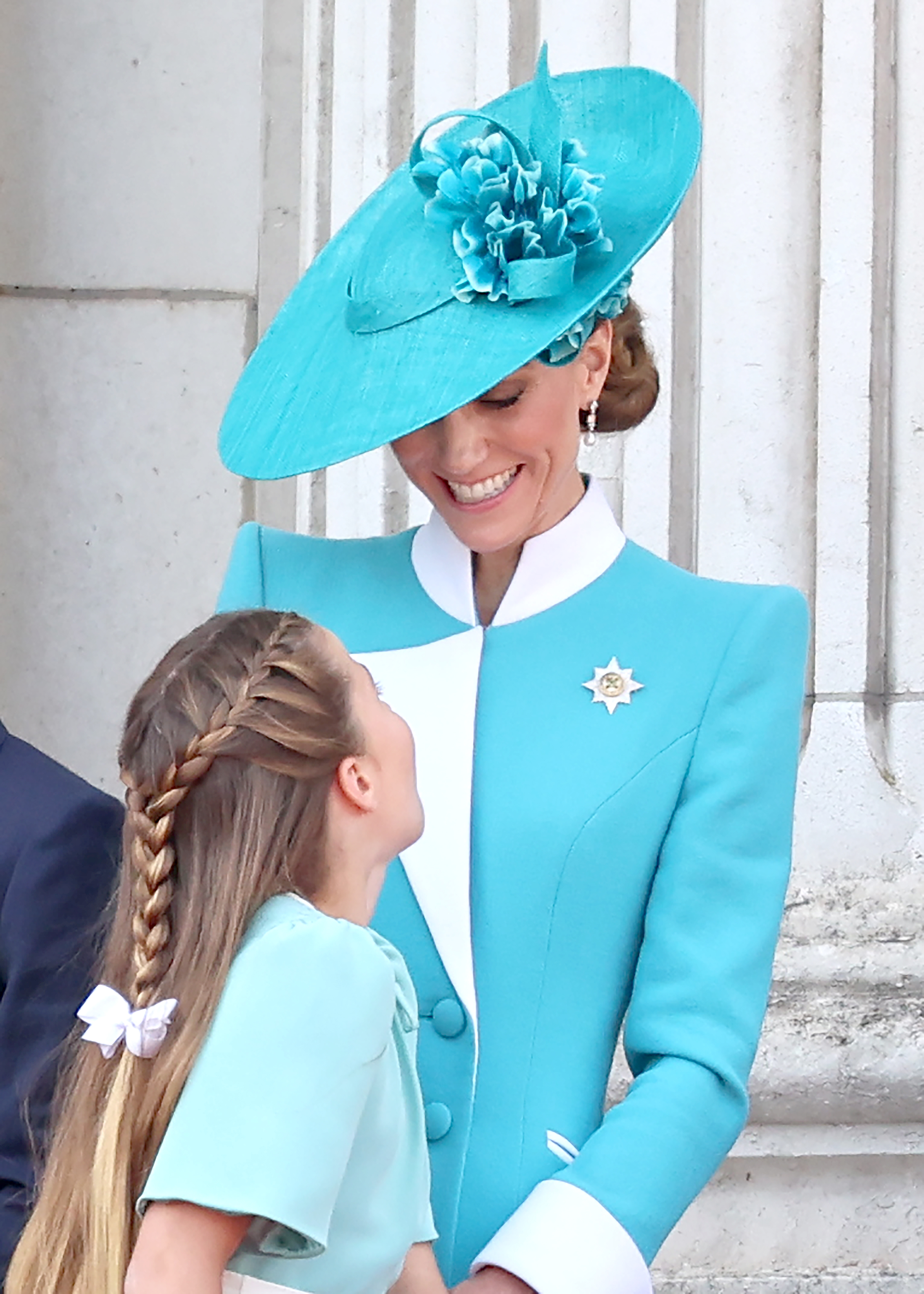 Princess Charlotte and her mother, Catherine, smile at each other on the balcony of Buckingham Palace during Trooping The Colour 2025.