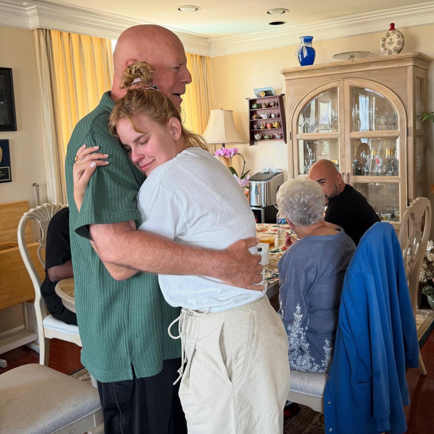 Tallulah Willis embraces her father, Bruce Willis, during a family gathering featured in the June 2025 carousel that later sparked a discussion about privacy. | Source: Instagram/buuski
