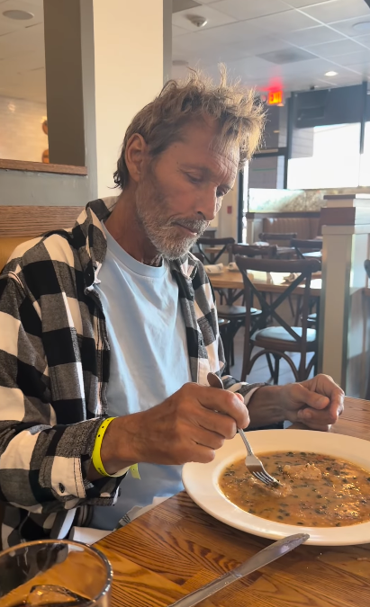 A restaurant outing shows Duguay sitting over a bowl of food, wearing a black-and-white plaid shirt. The everyday moment appears in the same family update that brought encouraging news about his recent medical results. | Source: Instagram/mrs__shay
