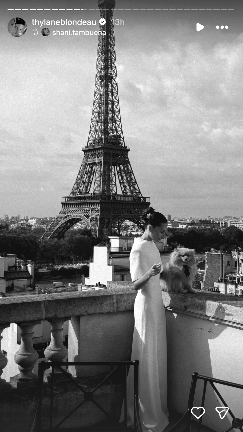 One of the day's standout images showed the bride in a sleek white gown posing with the Eiffel Tower rising behind her. | Source: Instagram/thylaneblondeau