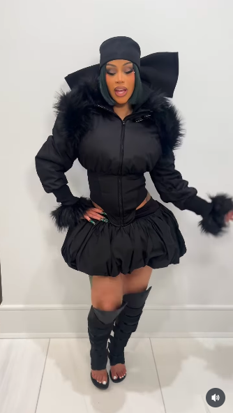 Cardi B strutting in a white-walled room in her all-black ensemble, posted on November 14, 2025. | Source: Instagram/iamcardib