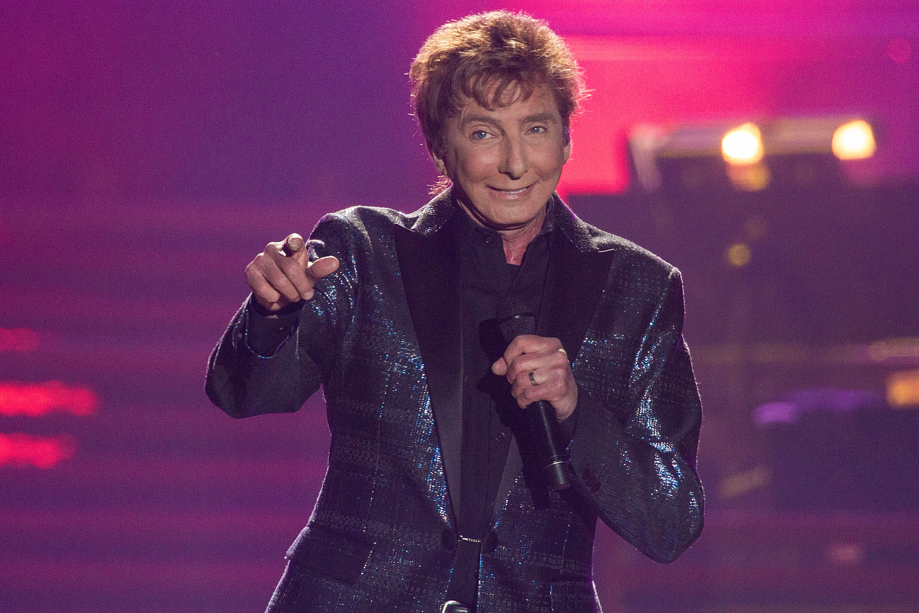 Manilow was still touring extensively in 2015, performing during his "One Last Time!" tour in San Diego. The image underscores how long he remained active onstage before the health problems that later forced him to postpone shows.  | Source: Getty Images