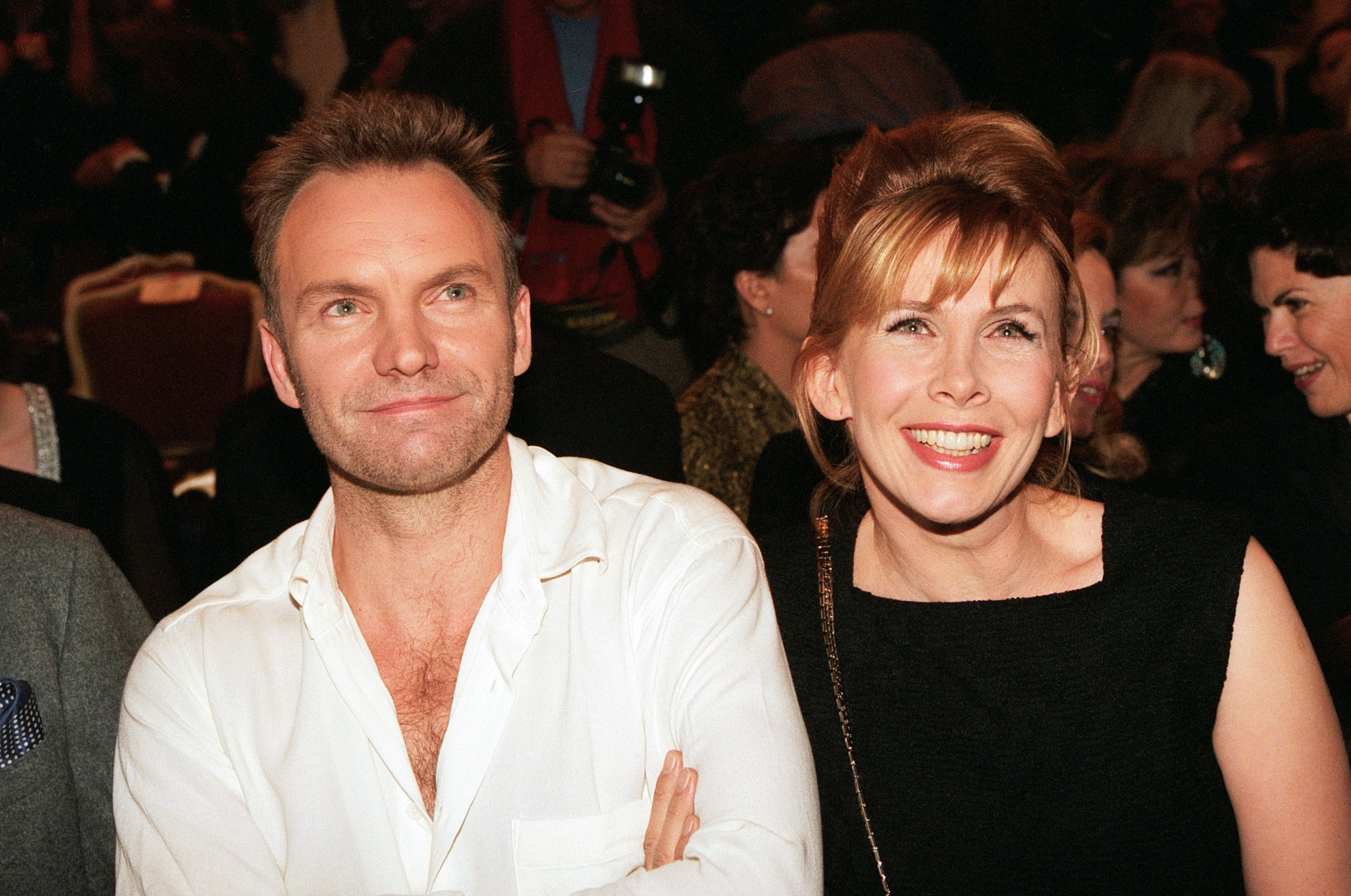 Trudie Styler, at 41, displayed an energetic, wide grin showing her teeth and clear, direct eyes with lightly defined brows, while attending the Versace Haute Couture Spring/Summer show with Sting on January 20, 1996, in Paris, France.