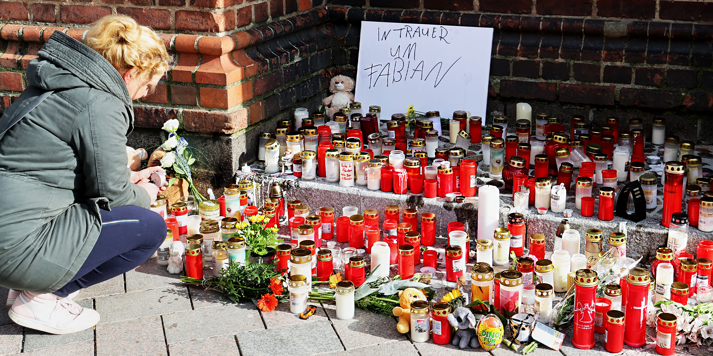 People lay flowers and candles for Fabian | Source: Getty Images