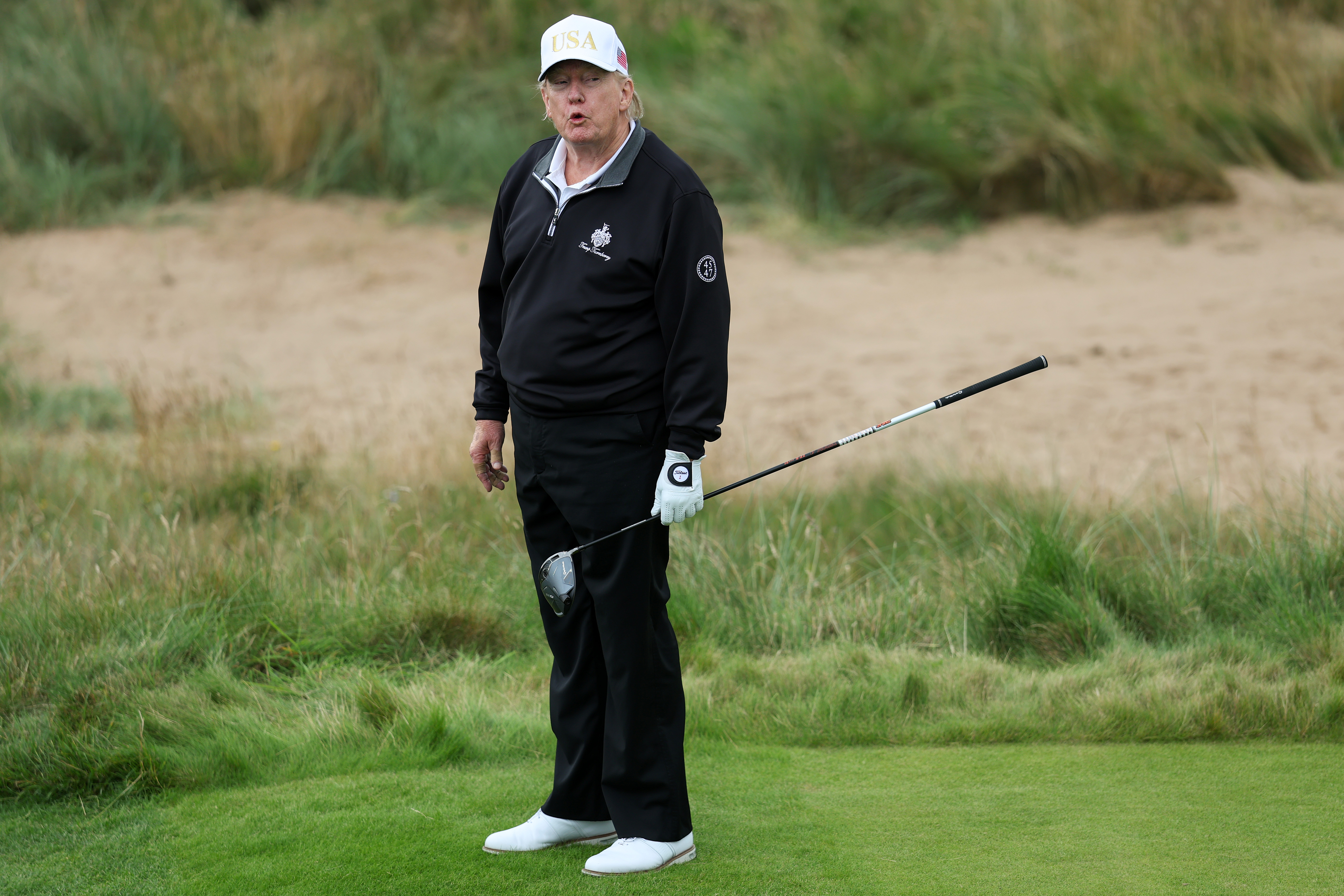 Donald Trump holds a driver after teeing off during the opening of his new golf course at his Trump International Golf links resort on July 29, 2025 in Balmedie, Scotland | Source: Getty Images