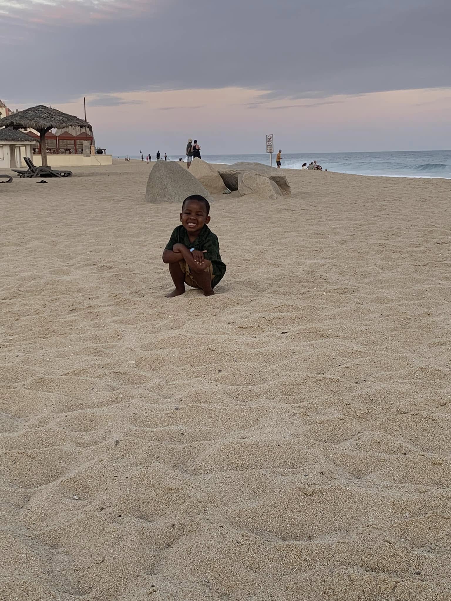 Nicholas Gray smiling on a beach, posted on August 11, 2022. | Source: Facebook/Kenzie Gray