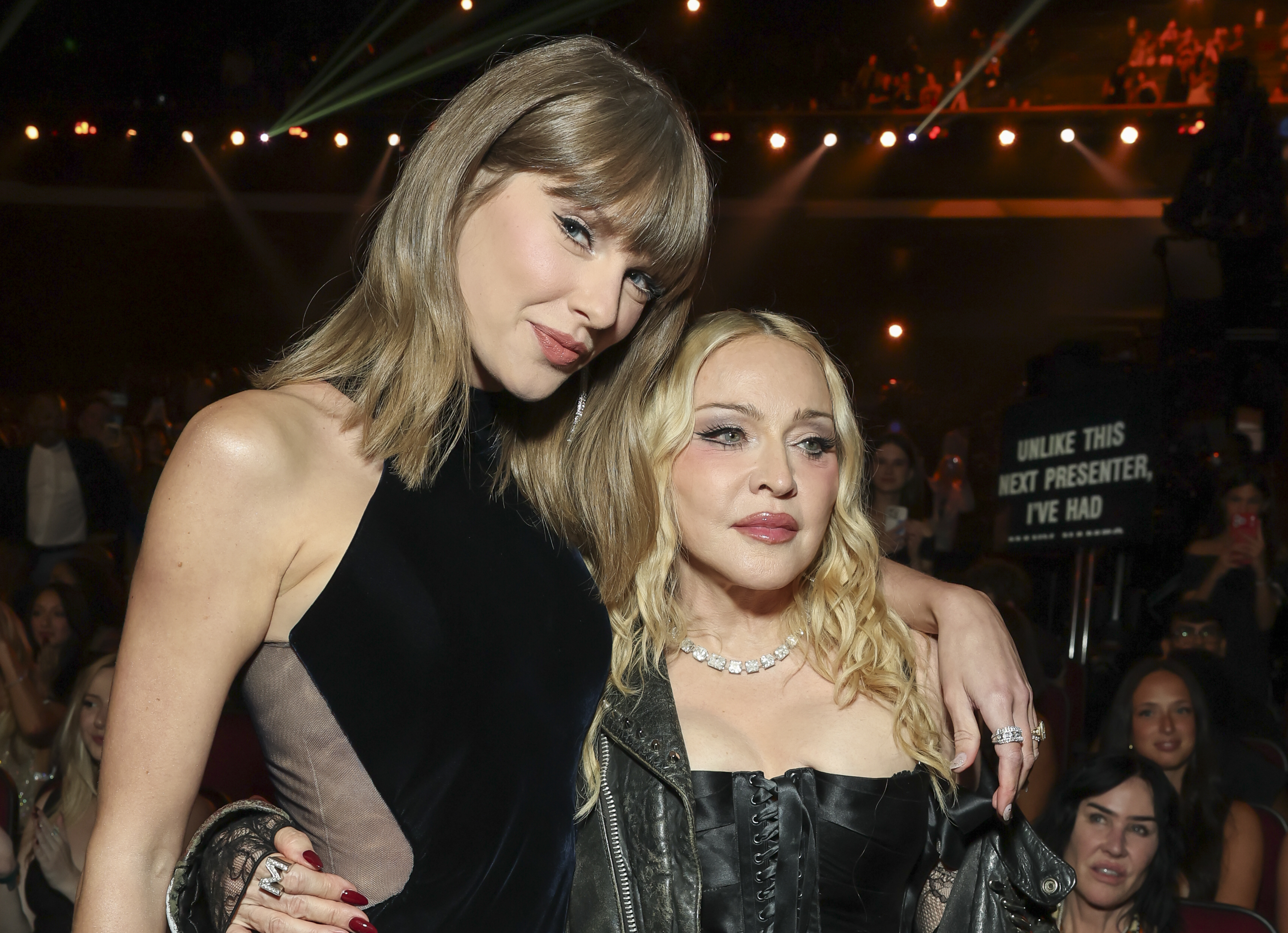 Madonna posed alongside Taylor Swift during the 2026 MTV VMAs, with her leather-and-corset styling contrasting with Swift's streamlined black look. The moment brought two different approaches to the night's darker palette into one frame.