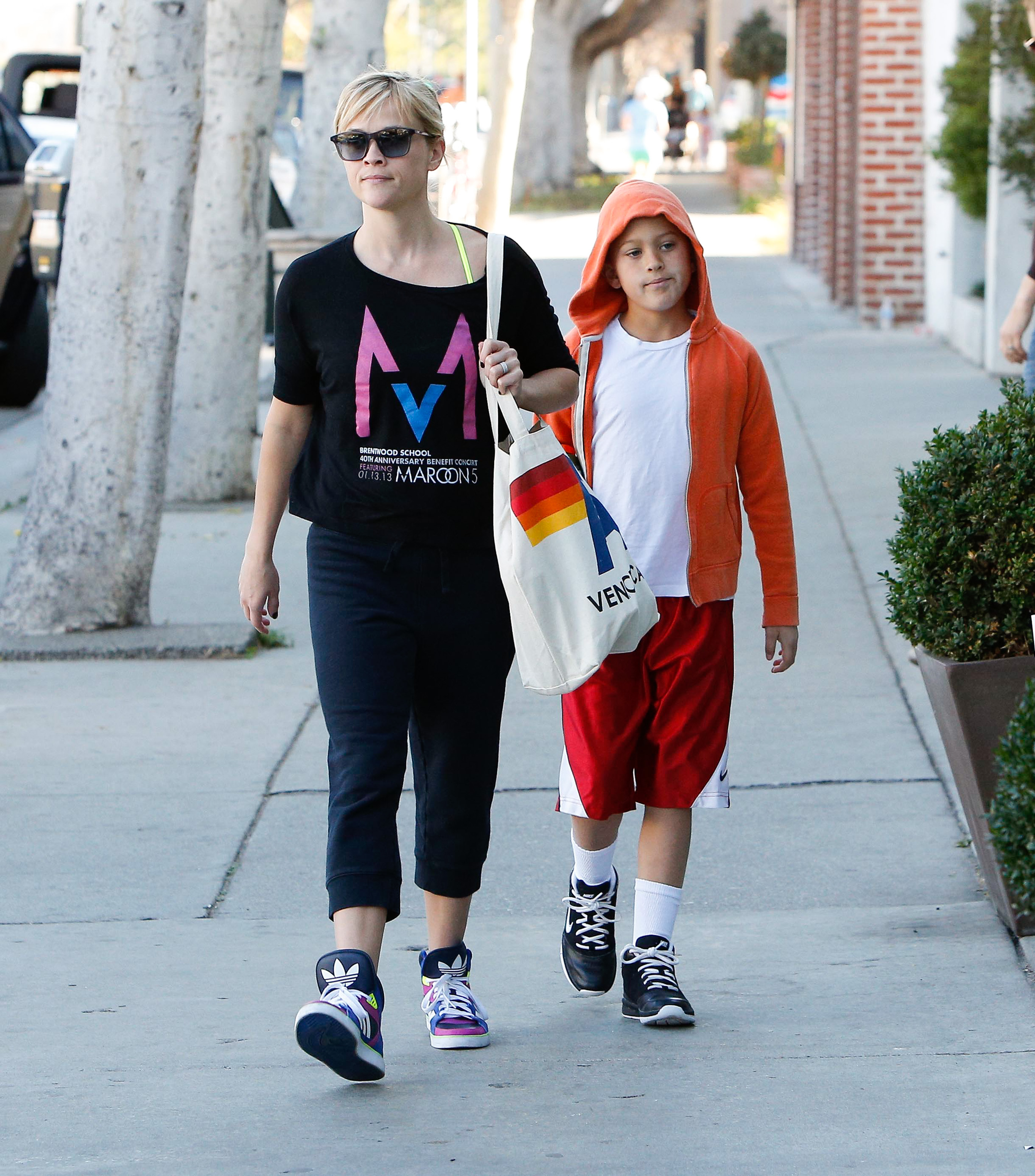 Hollywood events were only part of Deacon's childhood. In a more everyday moment, he walked beside Reese in Los Angeles, trading formalwear for an orange hoodie, T-shirt, and sneakers.