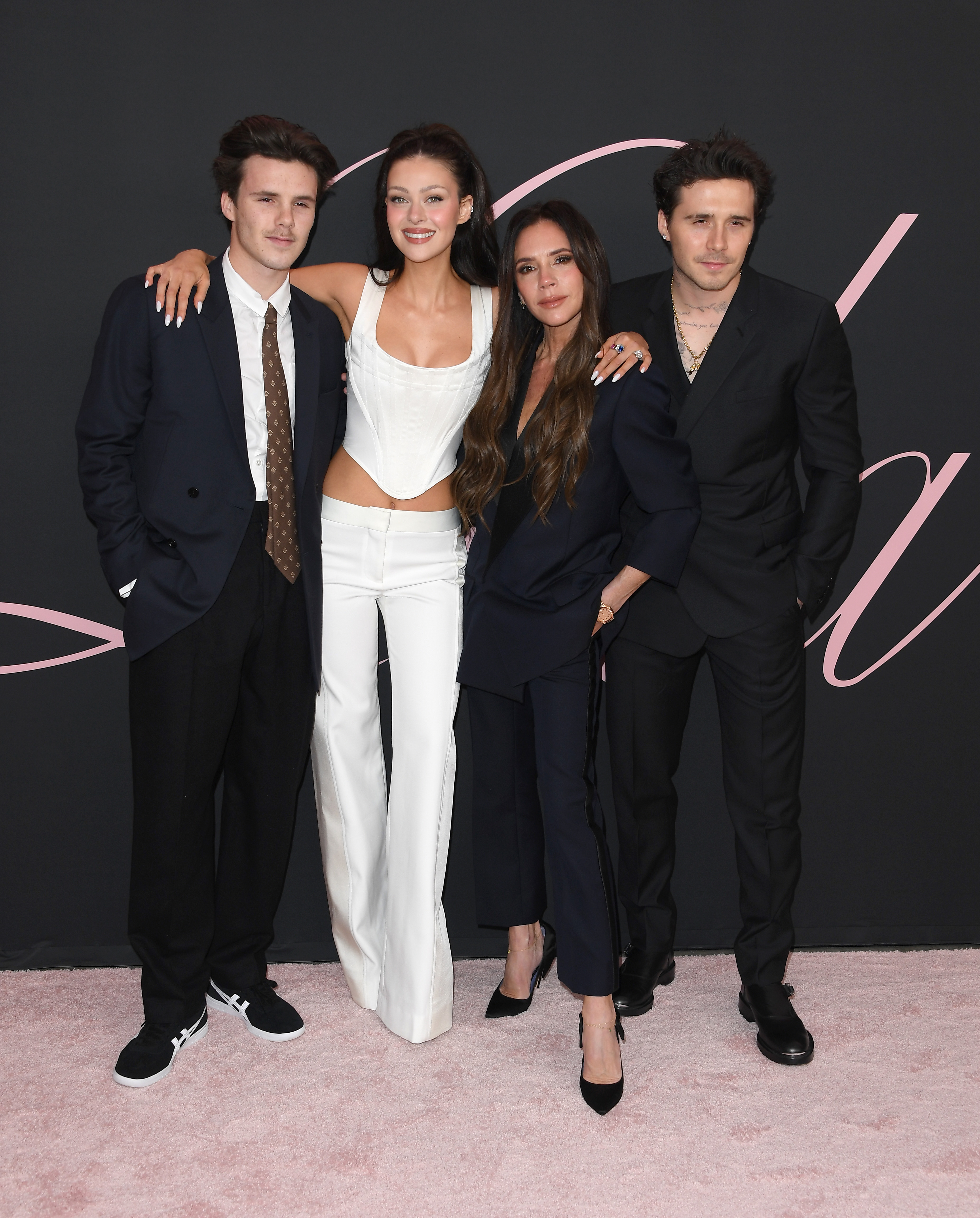 Romeo, Nicola Peltz, Victoria, and Brooklyn Beckham arrive at the Premiere Of "Lola" at Regency Bruin Theatre on February 3, 2024, in Los Angeles, California. | Source: Getty Images