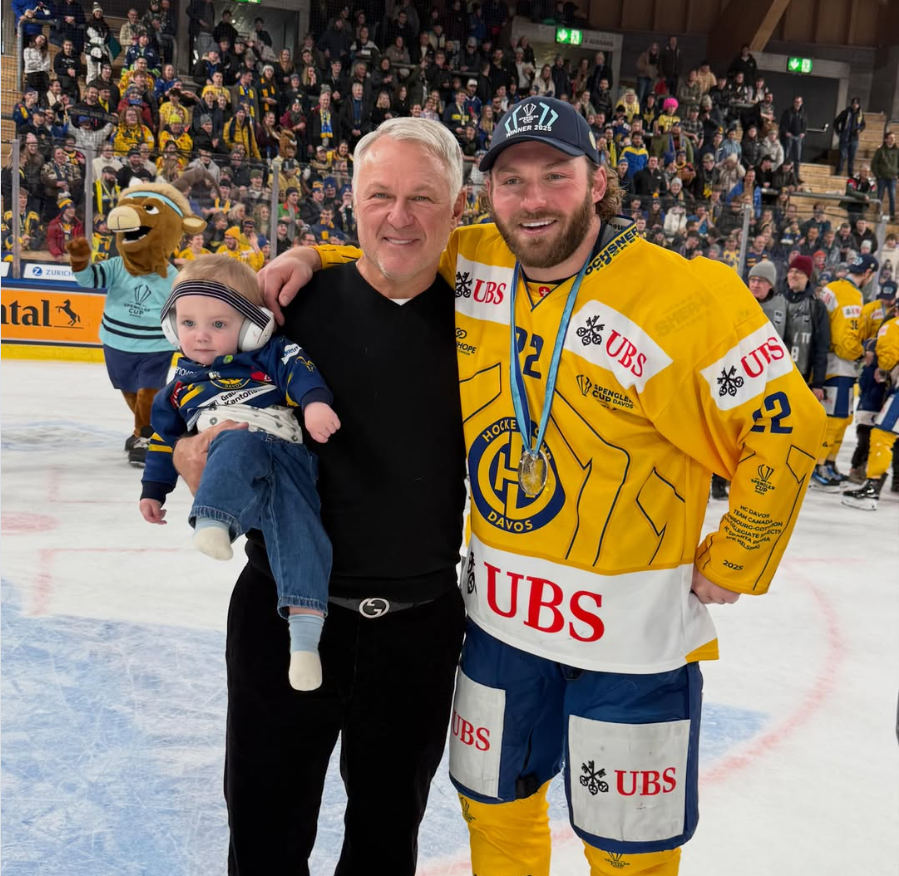 Claude Lemieux stands alongside his son, Brendan Lemieux, and grandson on the ice following a championship celebration. | Source: Instagram/brendan_lemieux