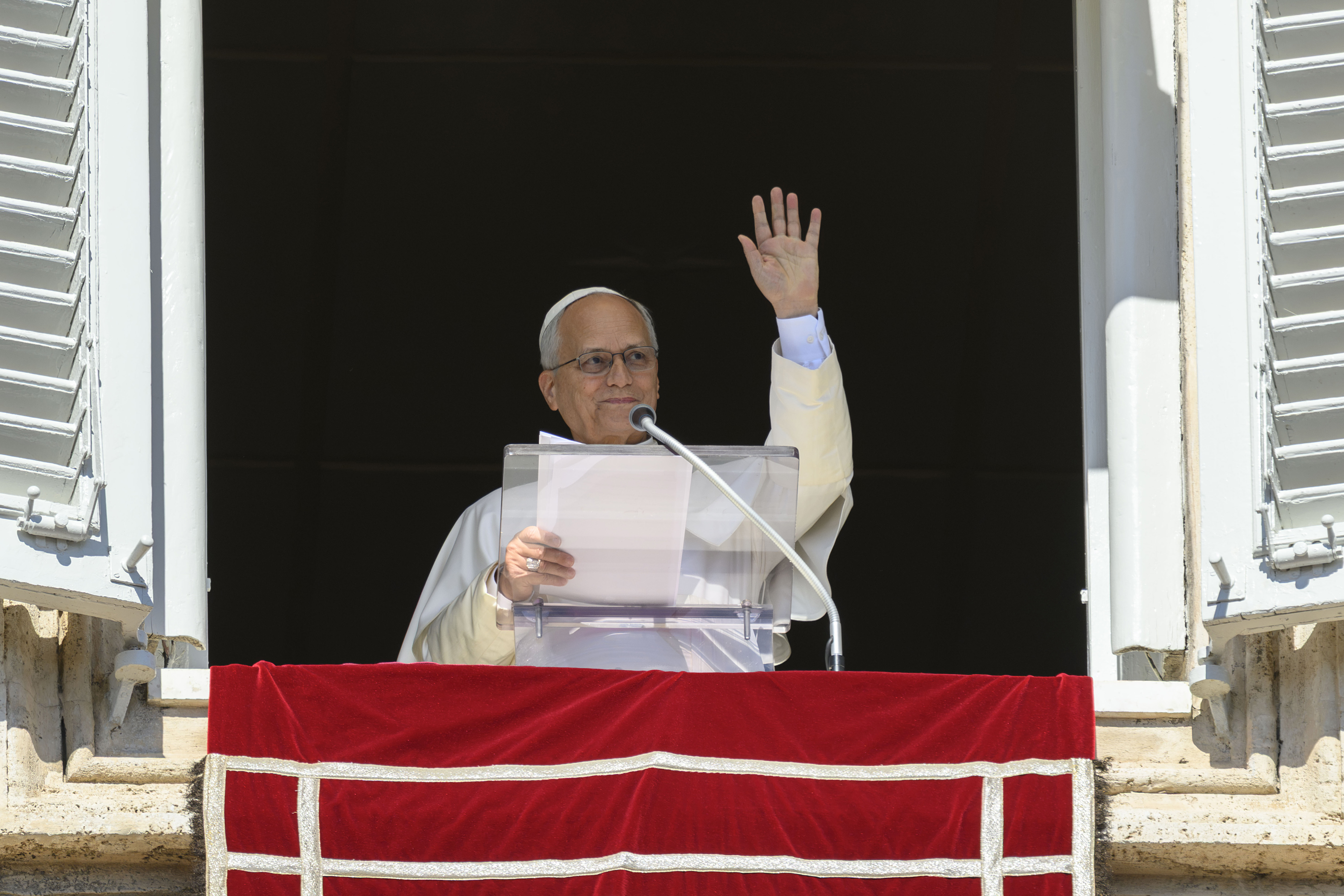 Pope Leo XIV waves to the faithful from a Vatican window during his Angelus address on October 11, 2026. Despite maintaining an active public schedule and having no previously known health problems, the pontiff announced that doctors had discovered a small, localized nodule in his lung that would require surgery. | Source: Getty Images