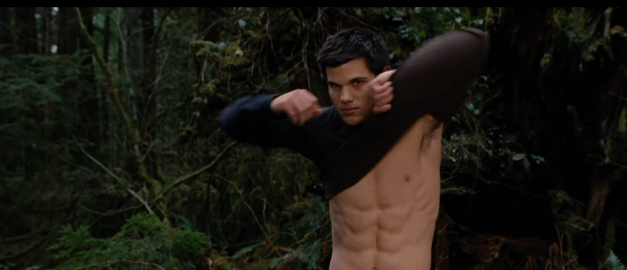 Taylor Lautner appeared as Jacob Black while pulling off a shirt during another scene set in the woods in footage from a video dated January 20, 2023. | Source: YouTube/Movieclips
