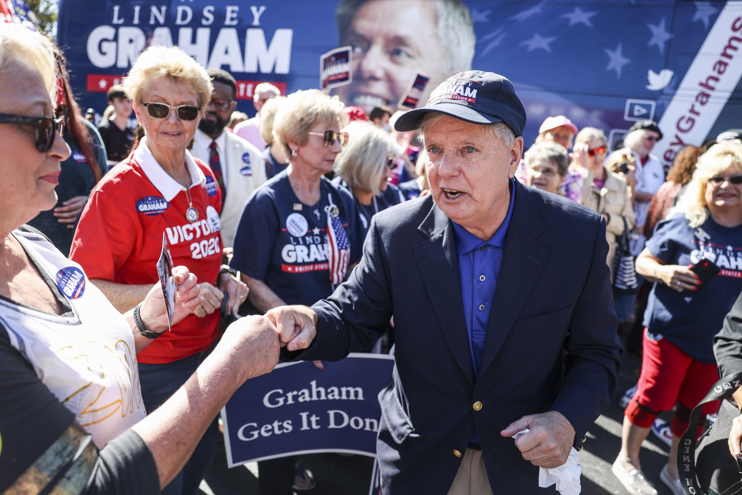 Lindsey Graham greets supporters during a campaign stop, pausing to shake hands and thank voters. The moment captured the retail politics that remained a key part of his reelection effort across South Carolina. | Source: Getty Images
